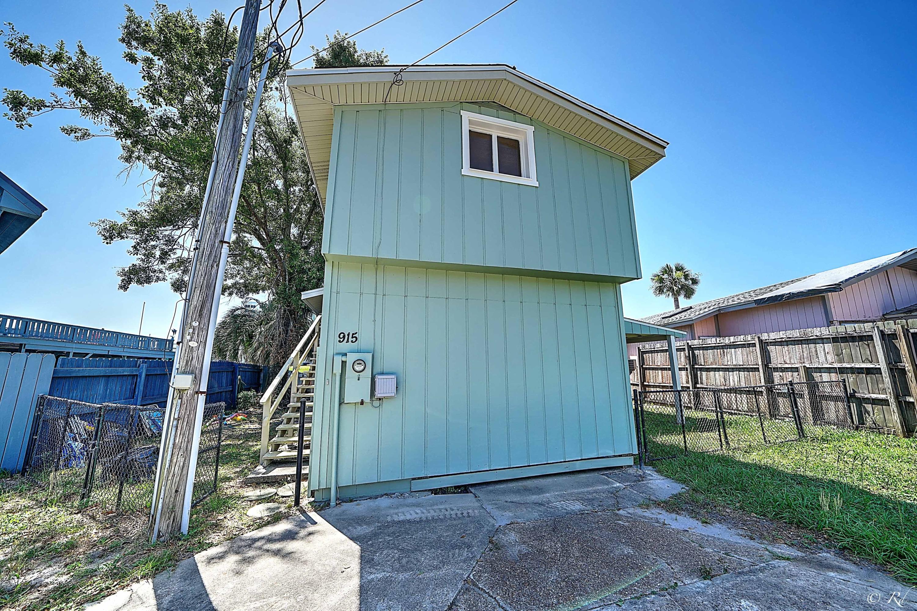 Perfect Beach getaway! This adorable WATERFRONT home has a lot to offer for a very low price! Upstairs there's one full bedroom, full kitchen, living room and full bath. Downstairs there's plenty of room for family and guests with one full bedroom, one and a half bath, and an area for a living room /kitchenette that is currently being set up to sleep the grandkids! Upstairs and downstairs decks have a view of the lagoon. Launch your boat just a few doors down and keep it there for the weekend or stay a while! Parking for up to seven or eight vehicles makes this great for a large group to enjoy! Laundry on site. There's also potential to enclose the downstairs carport for additional sleeping or possibly a game room! Fish cleaning station. Just a short drive to the white sandy beaches.