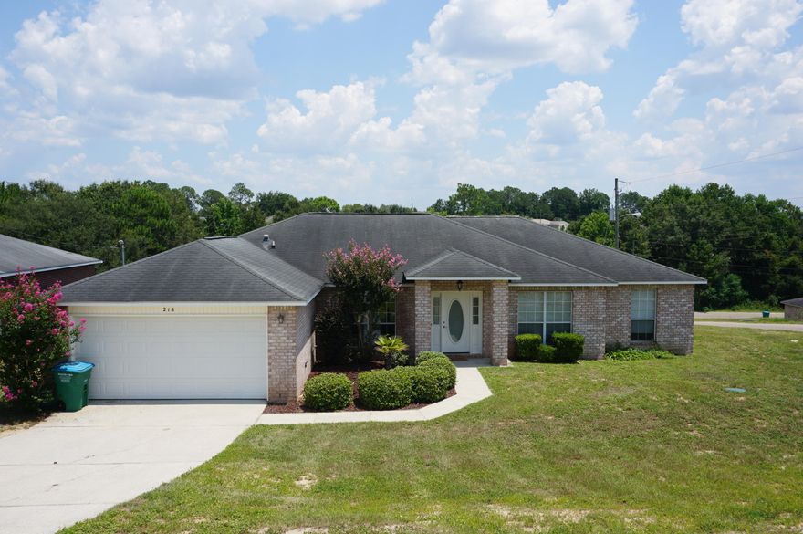 Available NOW!!!.......South Crestview home features easy commute and convenience to all bases, beaches & shopping. 4/2 Open concept living boasts dark wood flooring in the main living areas, kitchen island in the spacious kitchen, formal dining room or office space, split floor plan, large bedrooms, large laundry, eat in kitchen area, 2 car garage, and open back patio. No inside smoking. Pets will be allowed with a $400 non-refundable pet fee. Sloping front and back yard.