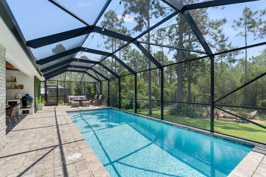 Rare opportunity to purchase this immaculate pool home on a 1 acre lot that backs up to forest views and is located in the popular Peach Creek subdivision! You won't find a better backyard at this price point! Enjoy your own Florida oasis with a screened-in pool surrounded by brick pavers, outdoor kitchen, fire-pit area, hammock, and pergola with bench. The huge backyard leaves plenty of room for sports, a playground, garden, and more! The fence has an 8-ft double gate, making boat storage a breeze. Peach Creek is located minutes from 30A's sugar-white sand beaches, schools, restaurants, shopping, and is a short drive from iconic Seaside and Rosemary Beach! Food trucks often visit this friendly neighborhood, and it has a new walking path perfect for outdoor activities. This well-designed "Victoria" floor plan has tons of natural light and neutral, coastal finishes, including granite countertops, EVP flooring, beautiful marble back splash, white cabinetry, shiplap, crown molding, tray ceilings, and decorative glass front door. The gourmet kitchen features a large island for additional seating and storage, huge pantry, newer stainless steel appliances with smart technology, and spacious breakfast/dining area. The large master suite has an en suite with soaking tub, tiled shower, double vanity and huge walk-in closet. The 3 guest bedrooms are nice-sized and separated from the master suite for privacy. There is also a hall closet for additional storage. This home also features fresh paint, smart home technology with smart lock and doorbell camera, upgraded lighting, new door knobs and drawer pulls, dedicated laundry room with cabinetry and front-loading washer and dryer on pedestals, and mudroom area with bench off of garage. The exterior has a full irrigation system, partial privacy fence with two gates, 2-car garage with epoxy floors and built-in shelves, expanded driveway that fits 4 cars, whole-house gutters, and covered front porch. The landscaping is beautiful and includes a variety of plants and lemon trees! The outdoor furniture is included and the outdoor kitchen has a built-in beverage cooler and plenty of storage, making pool parties easy. Enjoy outdoor lighting by the pool and listen to music on the Polk audio speakers with Sony Bluetooth amplifier. Swim in the pool, head to the beach, or bike the neighborhood! Peach Creek is known for its holiday festivities, friendly residents, and unbeatable location.  Schedule a showing today-this home is truly move-in ready! Buyer to verify all pertinent information in listing, including dimensions and acreage.