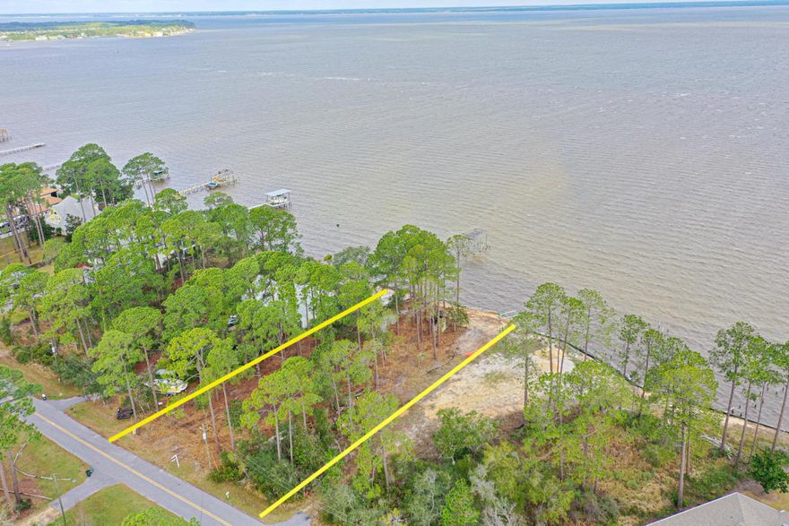 Amazing views of the Choctawhatchee Bay from the .58 acre lot with 95 Feet of BAY FRONT. This secluded neighborhood is convenient to everything - Sacred Heart Hospital, Shops at Grand Blvd., Topsail State Park, Baytown Wharf and Sandestin. This property has NO HOA's, is only 2 miles from the sugar white sandy beaches of the Emerald Coast. The property has recently been bush hogged, however may mature trees remain offering privacy. Plenty of room to build you Dream Home, Guest House, Bay front Pool, Boat Dock and Party Deck!! Not to mention there's room to park an RV and Boat. Lot comes with preliminary buildings plans for a 7500 sq/ft home. The Seawall is in place and just waiting for YOU!