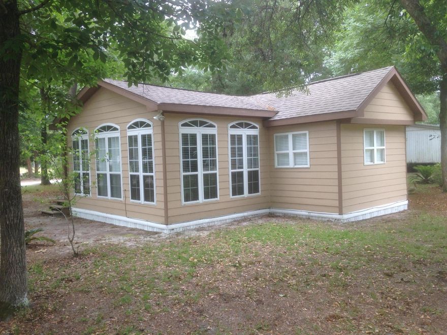 This home has many unique features that make it stand out. Vaulted ceilings in living room, kitchen and master bedroom, extra ceiling fans for comfort, decorative molding and trim throughout, floor to ceiling windows in living room, lighting tucked away above the crown molding, tasteful tile backsplash in the kitchen. The stackable washer/dryer are included with the home, as are the bunk beds in the third bedroom. Large corner lot with mature hardwoods. Conveniently located for boaters between Black Creek and Jolly Bay and only 20 minutes to the Gulf of Mexico.