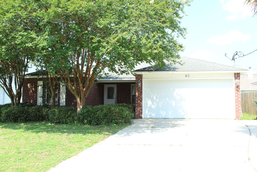 Brick home with 3 bedrooms and 2 baths, 1348 sq ft built in 2009! This home has a 30 year dimensional shingled roof and is located in close proximity to the white sandy beaches, shopping, and the military bases! Enter this home and notice the living room opens to the dining and kitchen areas! The living room has trayed ceilings. There is galley kitchen with granite countertops and back splash, black appliances, and chrome faucet and hardware. The appliances include a French door refrigerator, built in microwave, slide in electric stove and dishwasher. The flooring is tiled in kitchen and bathrooms, living room and dining areas. The bedrooms have carpet. There are two full bathrooms!