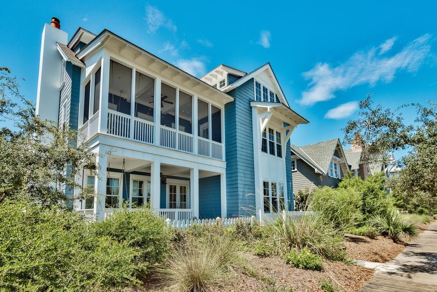 The beach community of WaterSound welcomed the Dream Team, architect Geoff Chick, builder Chris Clark along with the talent and personality of the owners of this Classic Coastal Beach home, featured in Coastal Living magazine. Perfectly placed on an East facing lot welcoming the rise of the sun from the cozy front porch swing, you enter a family room with a place for everyone. Surrounded by windows flooding the room with filtered light, the slipcovered sofas and upholstered chairs await. With the color palette of varying shades of blue & green with pops of cherry & chartreuse give way to a cheerful, ultra-casual vibe. The floors throughout the home are reclaimed heart pine rough cut and are one of the finishes that make this home special. In addition, wood planked walls painted