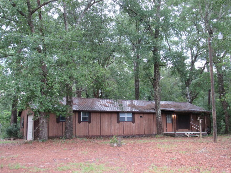 Price REDUCED! Priced below appraised value!!! Call today!!! Quaint Country Cottage on 4.95+/- ACRES! This property is priced BELOW appraised value and is located just 3 miles North of Vortex Springs on Hwy. 81. The 3/1 home has a metal roof, plenty of storage, updated water heater, large utility room and the appliances convey. The property is partially cleared with several shade trees as well as azaleas and gardenias. The backyard has a 24x24 Workshop and 10x12 shed. Bring the horses and farm animals, this property is unrestricted! Home is being sold ''as is'' and may not qualify for all loan programs. Call for your tour today!