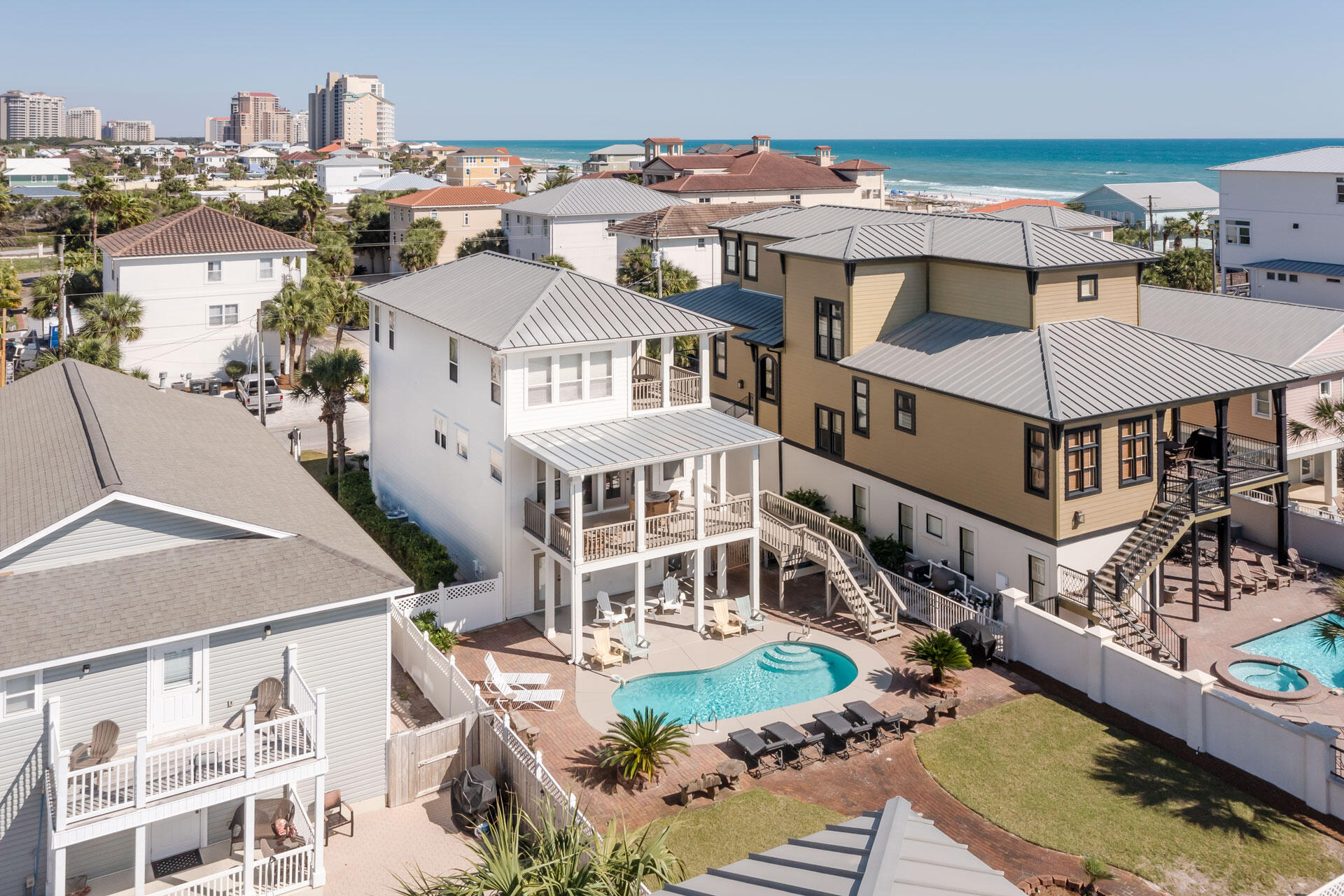 This recently updated home in Miramar Beach features 4 bedrooms and 4 bathrooms. The location is just a short stroll to the white sands and jewel toned waters of the gulf. However you don't have to go beyond the back yard to take a refreshing dip since a lagoon shaped swimming pool awaits you.The first floor of this three story home has a guest bedroom apartment with a full hall bathroom. This suite has direct access to a covered patio next to the pool. Upstairs is the main living area which is light and bright with honey toned hardwood flooring. A wall of windows with double doors leads out onto the wide covered balcony. The open living area features both living and dining spaces, and the dining area has room for an 8 person dining table.