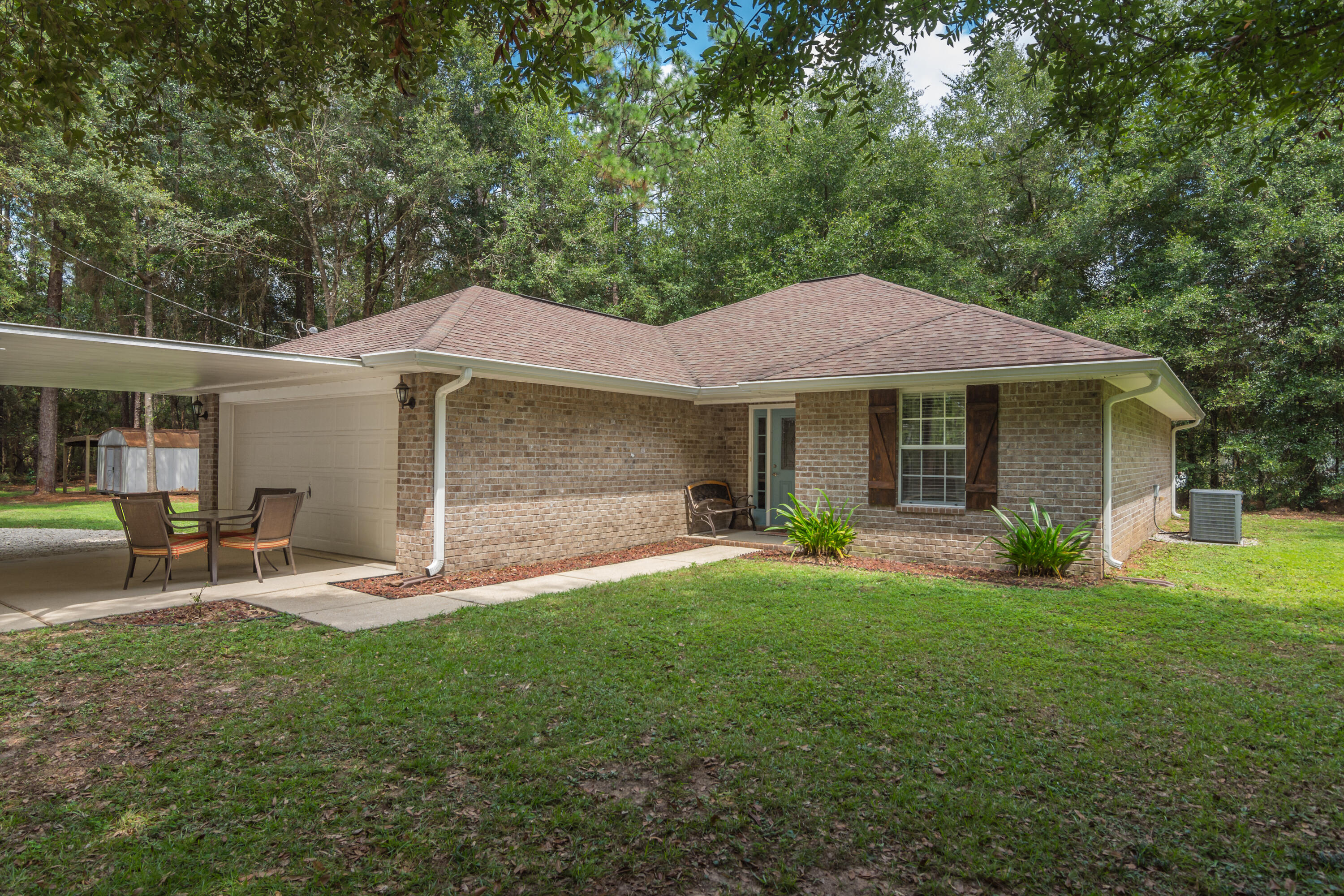 COME ON OVER TO THE COUNTRY!! Situated on approx 1.68 acres, this 3 bd/ 2 ba all brick home boasts a super cute interior and 2 car garage. The home features an open floor plan creating a spacious feel. The kitchen boasts freshly painted cabinets and plenty of counter space. The appliances include a new built-in microwave, stove/oven and dishwasher The master suite is spacious w/ dual vanities (new sinks/faucets), a garden tub and separate shower. The entire property is fenced and has an automatic gate. Included w/ the home is a 20'x20' carport adjacent to the double car garage and an 18'x20' freestanding carport. Seamless gutter system installed approx 6 months ago. The property also has a small shed and another open storage area w/ power and water. Schedule a viewing of this home today!