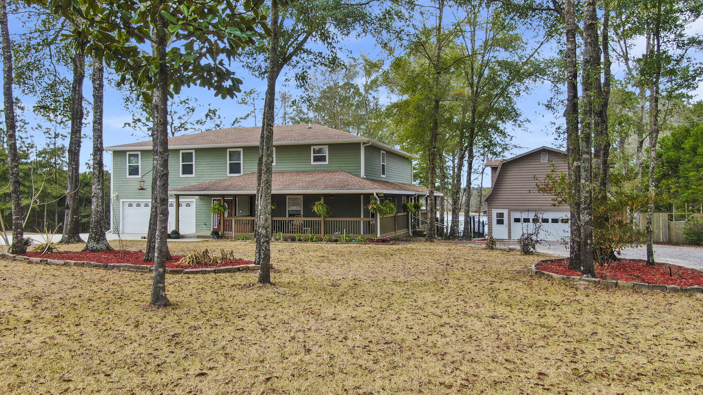 Unique opportunity to purchase one amazing Lake Juniper 5 bed/3.5 bath waterfront home with separate renovated 2 bed/1 bath apartment on almost 1 acre - OR add the home next door and live side-by-side to your family or friend (see MLS 890581 for details). This 6 years new Hardi-siding home has it all - and then some. The word over-engineered comes to mind! Downstairs you'll find an expansive great room and one of two master suites. The kitchen features all wood cabinets, breakfast bar, pantry, granite, a dining room fit for a family feast and a large living room, all overlooking the lake. Step out the back door to the wrap around porch and a few steps further to massive, beamed 23x23 covered porch that is made for entertaining! Further entertaining can be found with the