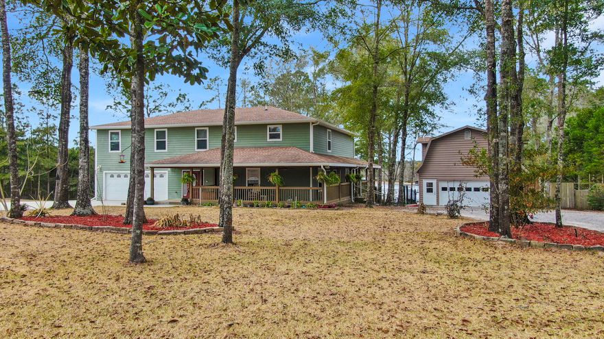 Unique opportunity to purchase one amazing Lake Juniper 5 bed/3.5 bath waterfront home with separate renovated 2 bed/1 bath apartment on almost 1 acre - OR add the home next door and live side-by-side to your family or friend (see MLS 890581 for details). This 6 years new Hardi-siding home has it all - and then some. The word over-engineered comes to mind! Downstairs you'll find an expansive great room and one of two master suites. The kitchen features all wood cabinets, breakfast bar, pantry, granite, a dining room fit for a family feast and a large living room, all overlooking the lake. Step out the back door to the wrap around porch and a few steps further to massive, beamed 23x23 covered porch that is made for entertaining! Further entertaining can be found with the