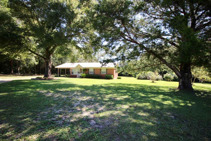 Picture perfect country home on 2 acres in DeFuniak Springs. If the curb appeal doesn't do the trick, the yard alone could make you want to move! The mature plants & trees look like they've been there forever. Inside, you'll find updates like freshly painted kitchen cabinets, laminate flooring a&brand new carpet in the bedrooms. Plenty of cabinets and extra storage in your oversized laundry room (perfect for Sam's Club trips and deep freezers!). Main bath has been completely renovated. Covered back porch looking out on your amazing back yard with 2 storage buildings, sycamores, oaks, grapevines, and elephant ears - that are frankly bigger than elephant ears! Metal roof & HVAC were replaced in 2016. One-car carport, paved road, 2 acres & a home that's neat as a pin. Who could ask for more?!