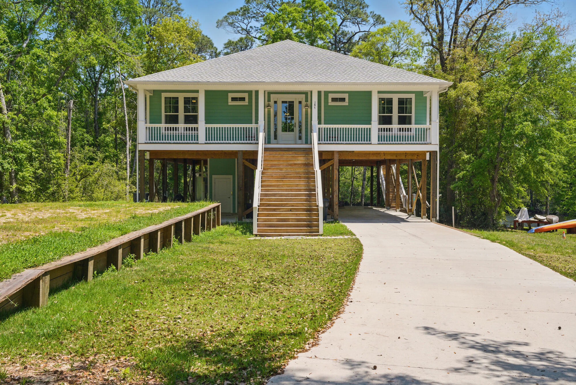 Architecturally designed and custom built in 2023 by Ralph Laird, this one-of-a-kind waterfront home sits on deepwater Alaqua Creek. Easy access to the Bay. Elevated on pilings with a built-in elevator, it offers both peace of mind and convenience. Inside, an open-concept layout connects the living, dining, and kitchen areas under soaring ceilings with expansive creek views. A custom breakfast bar and large windows invite light and conversation. Outdoors, enjoy a covered porch and elevated deck--perfect for relaxing or launching bay-bound adventures. With 3 bedrooms and 2 baths, every inch blends thoughtful design with natural beauty. Excellent fishing! Alaqua is famous for bream, bass, red fish & speckled trout! shown by appt. 24 hours notice