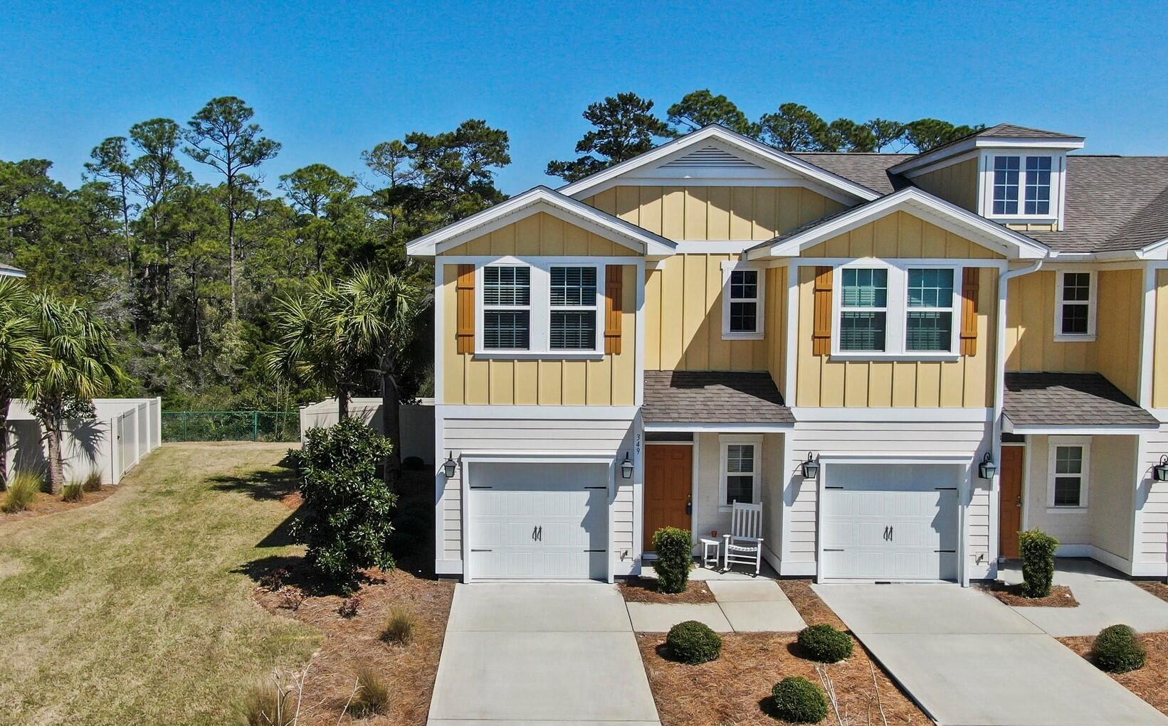 Don't miss this beautiful, maintenance-free, impeccable 3 bed, 2.5 bath, end-unit townhome with fenced in yard that backs up to a green belt! Newer construction, open floor plan has 2 additional living area windows for extended natural light, kitchen features granite countertops, bright cabinetry, stainless steel appliances as well as LVP flooring throughout the living and kitchen area with new carpet upstairs. The owner's suite includes an extra window, walk-in closet, tile shower with double vanity sinks & the laundry is located on the 2nd floor. New roof June 2024. HOA includes landscaping service, annual pressure washing, pest control, and community pool. Whisper Dunes is located just minutes from beach access, Pier Park and is only 20 minutes to ECP Airport. Furnishings negotiable.