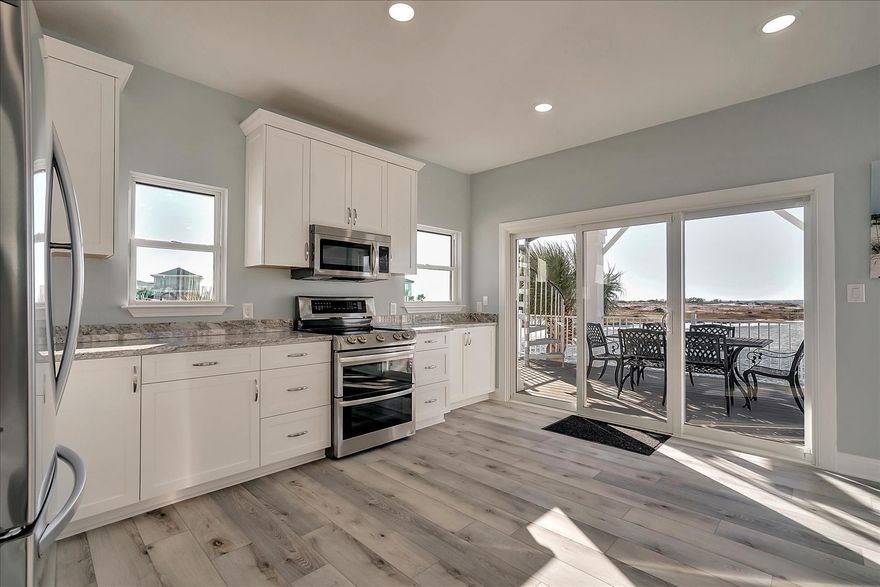 PRICE IMPROVEMENT! Looking for the perfect rental machine? This home has very impressive, proven rental income. Completely renovated and furnished beautiful waterfront home with the best water views on the beach from every room!! Sleeps up to 15 people which makes for an excellent rental. Massive 10x40 deck in the front and 11x40 deck in the rear for all your entertaining needs. This home is on the bay and has gulf views as well.