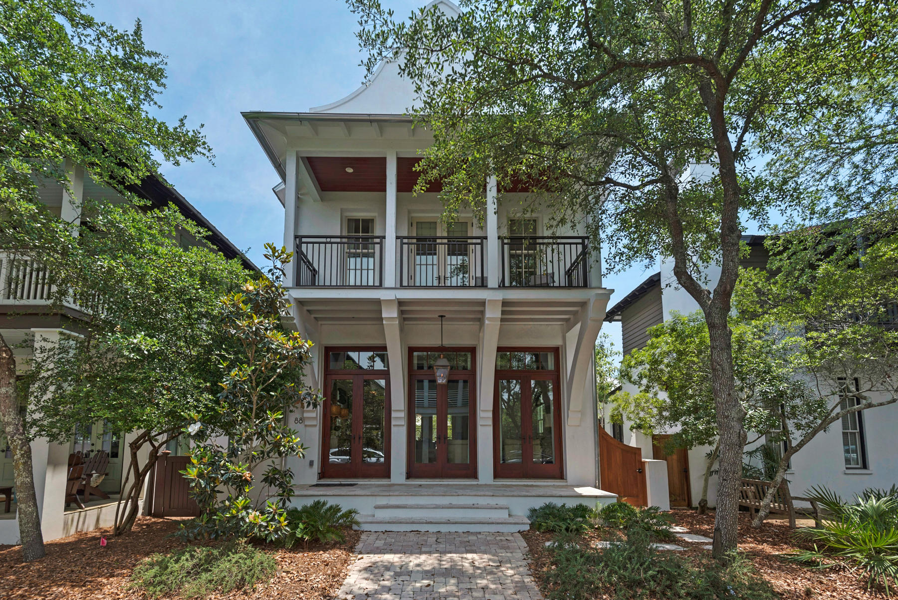 CLASSY CARRIBEAN ARCHITECTURE AND STYLISH INTERIORS make this an easy care Beach House for the relaxed Life at the Beach. Level 1 host an open and spacious Living Room/Dining Room/ Kitchen with French doors that flow onto front and rear porches. Level 2 enjoys the Master Bedroom with en suite bath and private balcony. The Guest rooms also have en suite baths with a king bed in one and 2 built in bunks in the other. A bubbly fountain contributes to the ambience of the courtyard where a pair of Palms provide shade. An outdoor shower adjoins an indoor bath and a storage room has ample space for beach toys.