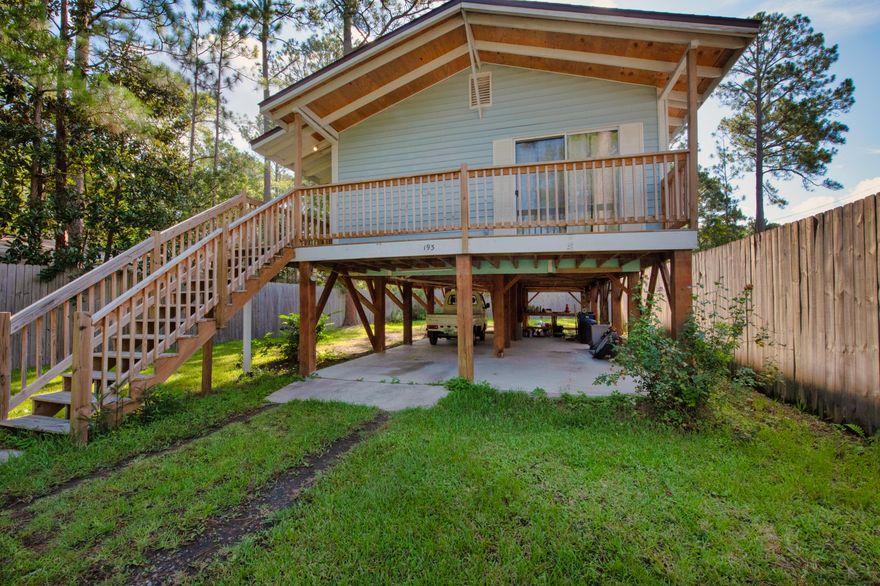 Welcome to this lovely stilted home in Santa Rosa. Through thoughtful design and strategic layout the home's 900 sqft lives much larger. The open kitchen concept has ample space for meal prep and enough cabinetry for all your storage needs. The master bedroom has a large glass door that leads to the large wrap around deck with peak-a-boo water views. Underneath the main living area, you'll discover a convenient carport and workshop space. This versatile area is wired and plumbed and can be enclosed into additional living space, providing endless possibilities to meet your unique needs.