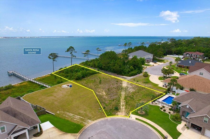 Incredible opportunity to build your waterfront dream home on this cleared 0.76-acre lot with 112 feet of pristine, sandy Santa Rosa Sound frontage. The high and dry 0.41-acre buildable area sits at a natural elevation, eliminating the need for pilings--saving significantly on construction costs. A gentle slope leads to deep water just offshore, ideal for boating, paddleboarding, and enjoying the coastal lifestyle. With waterfront property in Navarre becoming increasingly scarce, this lot is one of the few remaining undeveloped parcels offering both size and buildability. Zoned R-2, the property offers flexibility for a main residence plus a separate mother-in-law suite or rental unit for additional income. While located in a subdivision, this lot is exempt from the HOA-- no dues, no restrictions.
 
Positioned at the end of a cul-de-sac, the property has access to underground utilities: natural gas, electric, and sewer. The front of the lot is 14 feet above sea level, and the top of the seawall sits over 12 feetproviding peace of mind and added protection.
 
A detailed survey and wetland report, both completed within the past year, are available upon request.
 
Minutes from Navarre Beach and situated between Destin and Pensacola, this location offers both serenity and convenience. Opportunities like this in Navarre are vanishingsecure your slice of ready-to-build coastal paradise before it's gone.