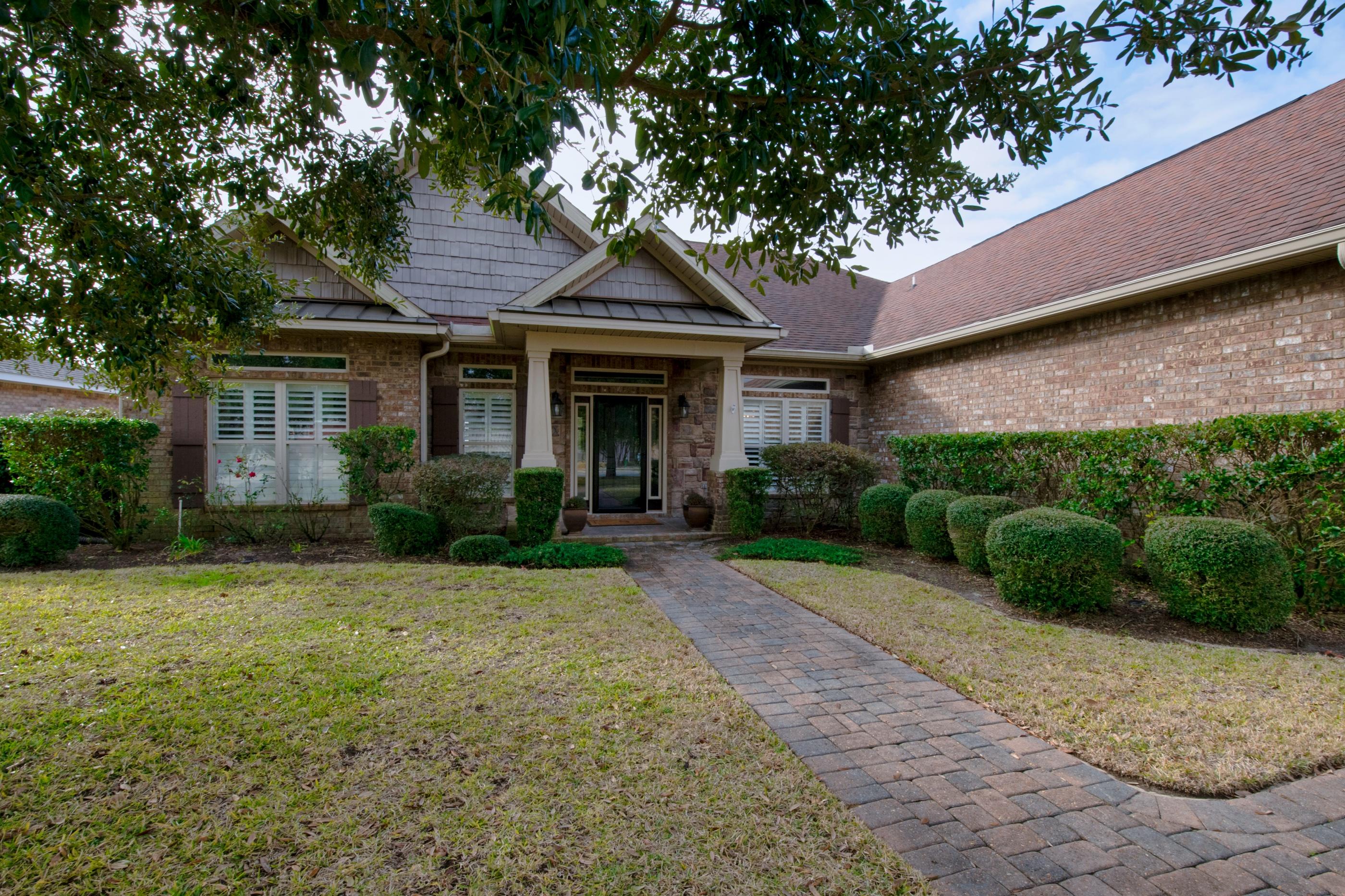 Here is your chance to live in the desirable Woodlawn Heights community! This immaculate craftsman style home has been impeccably cared for and tastefully upgraded. The home has many architectural details such as 10 ft ceilings, crown molding, coffered ceilings in Master Bathroom and Living Room. No carpet in this house and with over 3000sqft you'll have plenty of space to spread out and entertain. Speaking of entertaining, step outside to the newly screened in porch which leads to your expansive cobblestone patio with gas fireplace, custom outdoor kitchen and Photocell activated accent lights. Indoor/Outdoor speakers complete this entertainment package. Are you working from home? The master bedroom has a large office/sitting area that leads out to the screened porch. After a hard days..