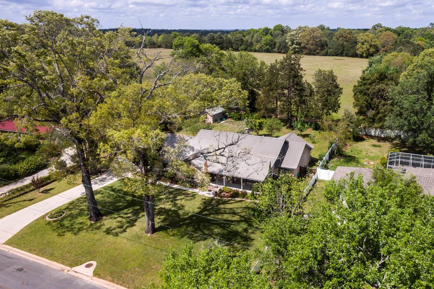 Charming and upgraded, this Crestview property is not one to miss! This home is spotless and pride of ownership is evident as soon as you pull into the driveway. Upon entering, you will find a large office/formal living room to your right and a formal dining room directly across the hall to your left, covered with hardwood flooring. The bright and updated kitchen wows with new white/gray cabinetry, subway tile backsplash, and granite countertops. Plenty of space to dine in the kitchen! Attached to this area is a massive laundry/utility area, with an entire wall flanked w/storage cabinets.The living room is spacious and has a beautiful brick fireplace as the centerpiece.The entrance to the Florida room is found thru the living room and is the perfect spot to relax with a glass of sweet tea. All bedrooms have great light and space, but the 16x17 master bedroom really brings a wow factor. This connects to a large bathroom area with dual vanities, tub/shower combo, and massive walk in closet. The guest bathroom features a tiled shower with gorgeous subway tiles and granite countertops. As beautiful as this home is in pictures, it is sure to wow in person! Be sure to check out the perfectly maintained backyard area, complete with paver walkway and pergola. Brick workshop also offers up additional storage space and has a cute little patio area. Not your everyday Crestview property!