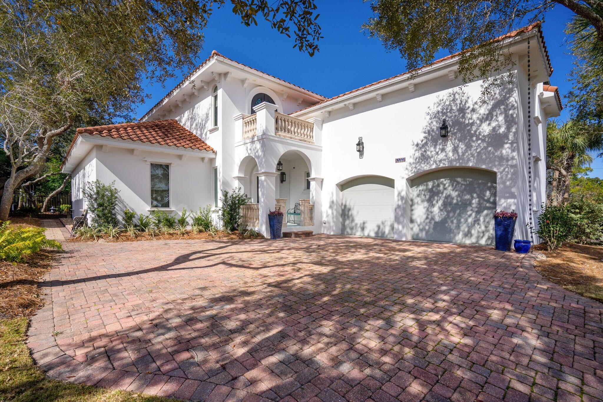 This amazing Mediterranean villa located in One of Destin's favorite neighborhoods, Destiny West is a gated community situated directly across Scenic 98 from the stunning white sand beaches and sparkling waters of the Emerald Coast! Besides the beach, Destiny's amenities include a clubhouse, fitness center, swimming pool, hot tub, tennis, basketball court and gated access. This home provides luxury, conveniences and a practical floorplan well suited to modern lifestyles! Made of ICF construction and located on a cul-de-sac, The primary living area is on the first floor, plus the property offers incredible outdoor living, dining, relaxing, and entertaining spaces surrounding the gorgeous salt-water pool. The kitchen features two-tone granite countertops, solid cherry cabinets, glass backsplash, and stainless Thermador appliances including a 36" 6-burner cooktop, hood 42" built-in refrigerator, Sharp microwave drawer and a Uline wine refrigerator. The master suite is located on the first floor, as is a utility room with office space and a full bath. The main staircase leads to two bedrooms that share a bath and a balcony overlooking the pool.