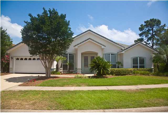 NEW PRICE! Step into this inviting home with a large tiled foyer and discover the open feel of a well designed floor plan. New hardwood floors are in the formal living room, dining room, and master suite. Windows throughout the home allow plenty of natural light. Ceiling fans are in every bedroom, living room, family room, and patio. The spacious kitchen features all stainless appliances with a gas stove. Just around the corner from the kitchen is a full-size installed wine cooler with dual-temp drawer storage for your fine wines. The family room features a gas fireplace and opens up to a large screened in patio that overlooks a beautiful landscaped backyard. French doors lead to the private master suite, which is separate from the other 3 bedrooms. In the master suite, you will notice