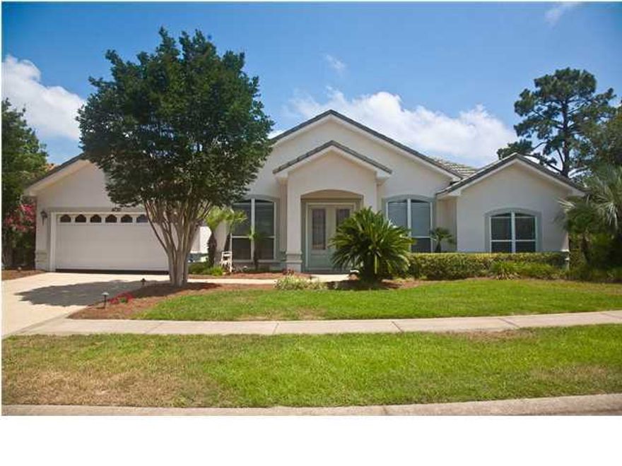 NEW PRICE! Step into this inviting home with a large tiled foyer and discover the open feel of a well designed floor plan. New hardwood floors are in the formal living room, dining room, and master suite. Windows throughout the home allow plenty of natural light. Ceiling fans are in every bedroom, living room, family room, and patio. The spacious kitchen features all stainless appliances with a gas stove. Just around the corner from the kitchen is a full-size installed wine cooler with dual-temp drawer storage for your fine wines. The family room features a gas fireplace and opens up to a large screened in patio that overlooks a beautiful landscaped backyard. French doors lead to the private master suite, which is separate from the other 3 bedrooms. In the master suite, you will notice