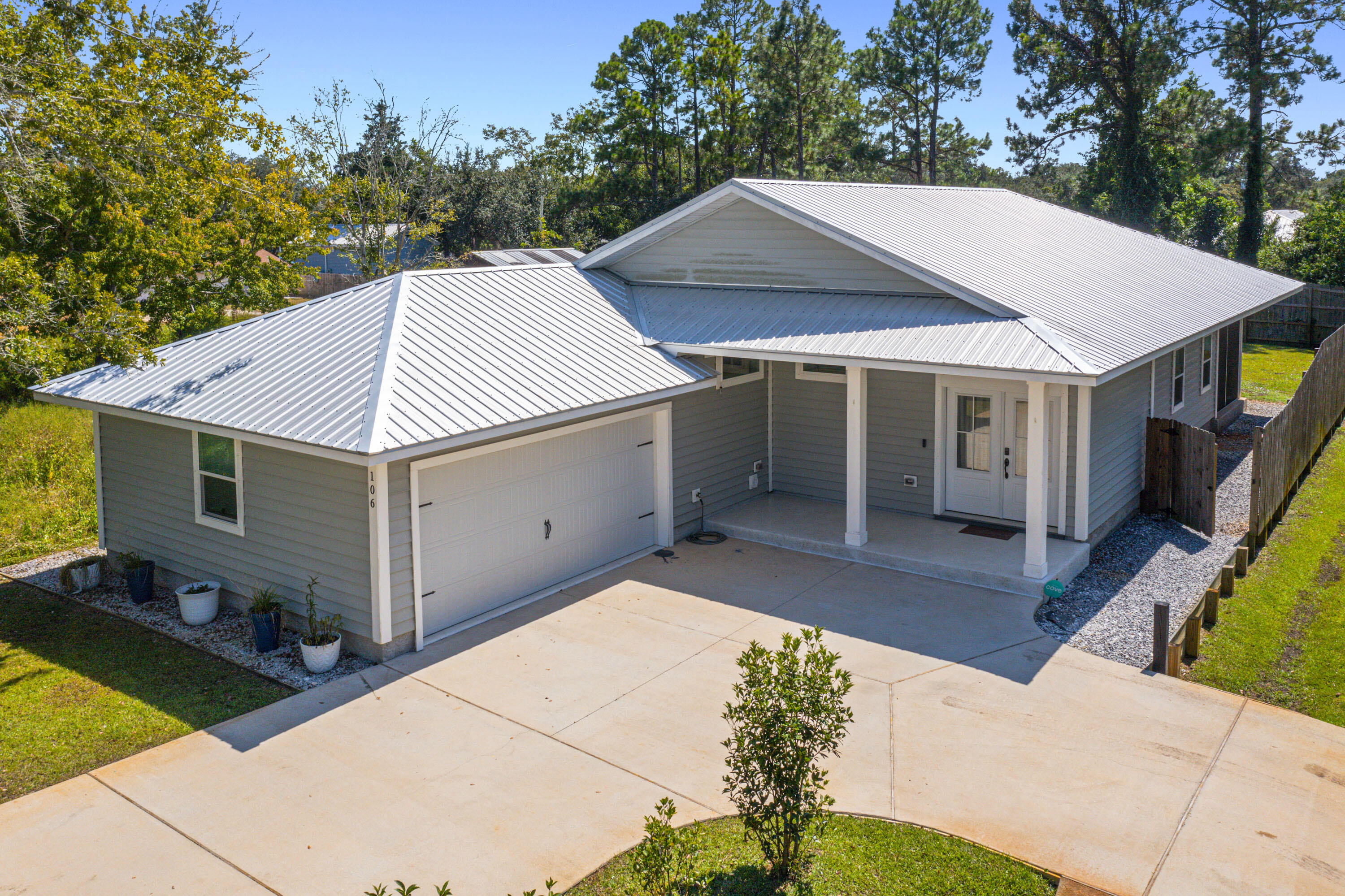 Welcome to this beautifully crafted 2022 home in the quiet Villa Tasso neighborhood of Niceville. This 3 bedroom, 2 bathroom residence offers 1,838 sqft of thoughtfully designed living space with a side-entry 2-car garage and durable metal roof.Inside, enjoy modern finishes including quartz countertops with butcher block accents, premium vinyl flooring throughout, and tile in all bathrooms. The spacious Primary Suite features 10' ceilings, a large walk-in closet, and a stunning walk-in shower with bench seating. Step out onto the screened-in back patio--perfect for relaxing evenings--accessible from both the living area and Primary Bedroom. Built with energy efficiency in mind, the home includes a radiant barrier, blown-in insulation, and a 240V EV charger in the garage. Conveniently located just minutes from the Mid-Bay Bridge, providing quick access to shopping, dining, and the world-famous white-sand beaches of Destin.