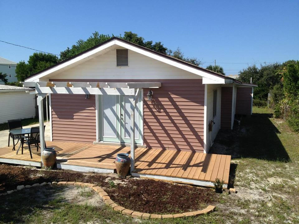 This beautifully renovated beach house is only STEPS from the Gulf of Mexico. The perfect beach residence for a second home or a permenant residence. This home offers a newly renovated kitchen with oak cabinets, White appliances and Plenty of space... The bathrooms are also newly renovated... Main bath has fish tank looking window for the perfect beach effect. Both bedrooms have hardwood floors and are spacious. There is a bonus room off the kitchen that can be used as an office or sitting area. The private laundry room has tons of storage. Imagine lounging on the front porch of this cozy beach house listening to the palm trees sway in the gulf breeze. Hurry! A Beach house this close to the gulf will be SOLD before you know it!