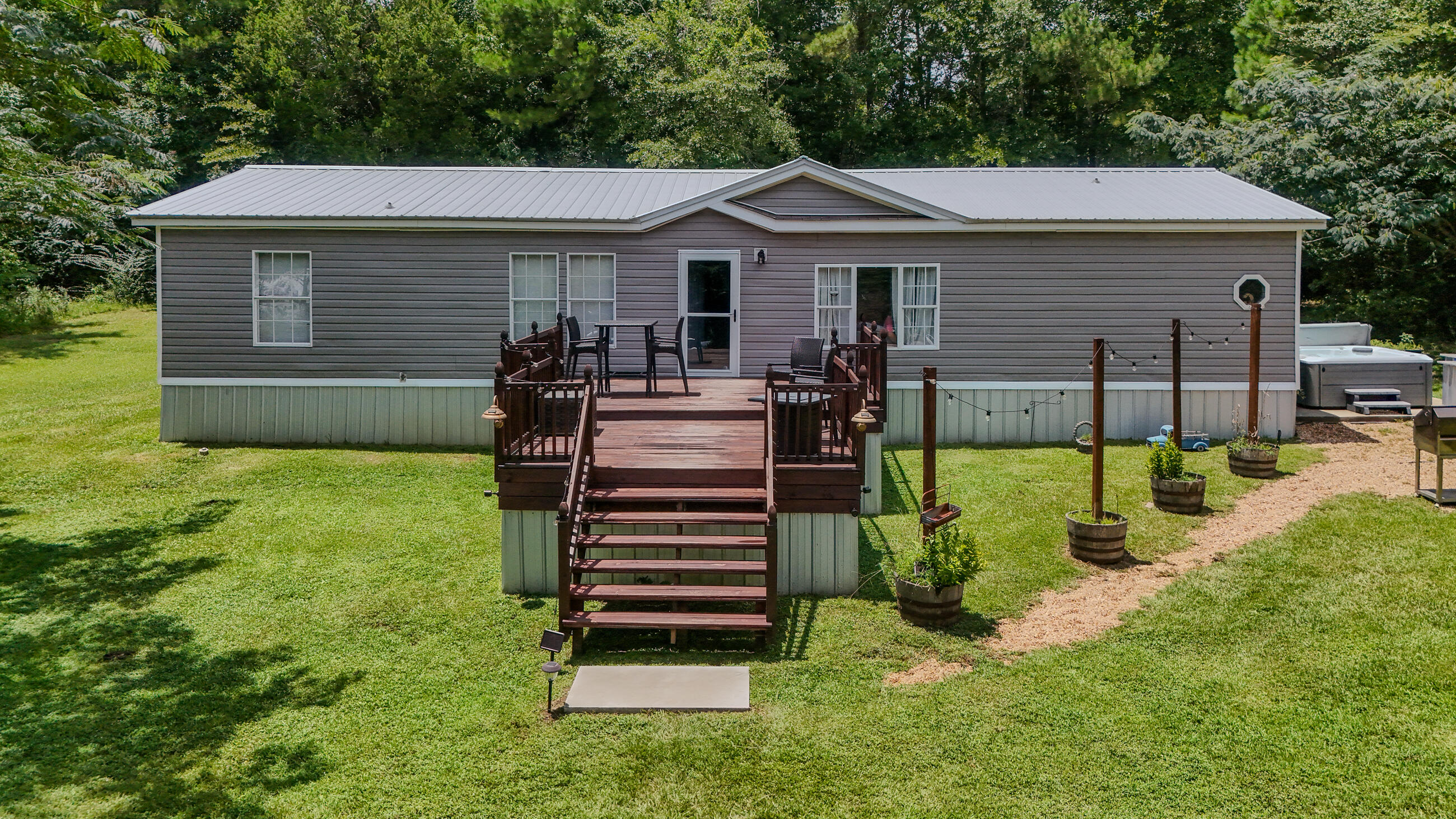This impeccably maintained home is nestled on 21.25 acres with an out of town, country feel but just 8 minutes from Hwy 331 S.! This location is convenient for commuting to a multitude of places including the beaches of South Walton (45 minutes), Egin AFB (45 minutes) or Interstate10 (10 minutes). Upgrades to this 3 bedroom, 2 bath home include custom kitchen cabinets, one year old vinyl siding with Tyvek wrap underneath, and a 3 year old metal roof with water rubber waterproofing underneath. Outside you will find an inviting hot tub on concrete slab, a 32x40 pole barn with a 12x32 insulated bay with concrete flooring and a 12x24 double lofted build-rite building. SEE MORE... Another gem on this property is a 12x32 tiny home, double lofted and completely renovated. 3 parcels make up the total acreage. A creek winds through the 20.25 acres behind the home. Schedule your showing of this beautiful home today.