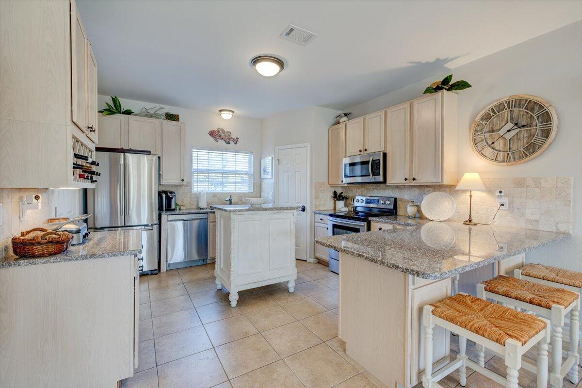 Located in the heart of 30A this townhome is an ideal investment property or beach retreat. This two bedroom, 2.5 bath, 1400 square foot townhome is very spacious and well-appointed with a nice open floor plan. Kitchen is updated with stainless appliances, and granite counter tops extend to create a nice breakfast bar. Tile floors flow seamlessly into the living room and dining area. Slide open the patio doors to extend your living space outdoors and enjoy the wonderful views and sunsets above the treetops. Second floor leads up to two en-suite bedrooms and an additional balcony for reading and relaxing off the master bedroom. Units at The Legends community on Scenic 30A include covered parking and storage for bikes and all of your favorite beach toys. Amenities include 2 community pools,