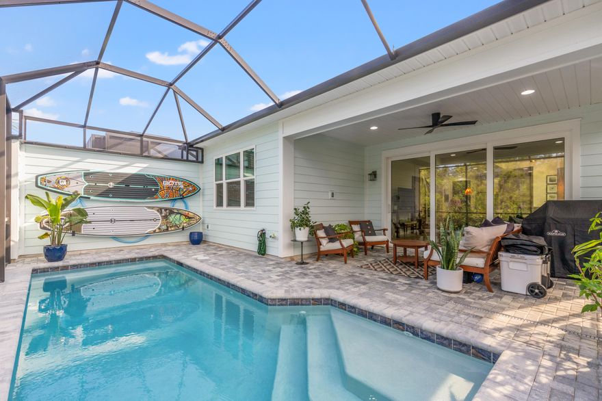 This impeccably upgraded Tortola Villa is designed for modern coastal living, offering 2 bedrooms, 2.5 baths, a versatile flex room, and beautifully integrated indoor-outdoor spaces. Expansive sliding glass doors invite natural light into the bright, airy interior and extend the living area to a private screened lanai with custom pavers, a heated saltwater pool, and tranquil preserve views -- creating a seamless connection to the outdoors.Inside, thoughtful upgrades elevate this villa's aesthetic. Luxury vinyl plank flooring runs throughout, complemented by 8' doors, designer fixtures, recessed lighting, and sleek black hardware. The gourmet kitchen features 42'' upper cabinets with crown molding, granite countertops, a full-height backsplash, premium stainless appliances including a gas range, and pullout shelving in the pantry and lower cabinets for effortless organization.

The primary suite serves as a calming retreat with a spa-style zero-entry tiled shower featuring dual rain and standard showerheads, a seamless glass enclosure, and granite vanities with framed mirrors. A custom-designed walk-in closet enhances the space, offering tailored organization and elegant storage solutions.

A spacious guest suite offers privacy and comfort with its own walk-in closet and an en suite bath featuring an upgraded walk-in shower. Additional features include a flexible bonus space that could be converted to a third bedroom, an insulated garage with attic storage and utility sink, and premium LG appliances, completing the functional design.

Latitude Margaritaville Watersound is a premier 55+ community situated along the Intracoastal Waterway, just 7 miles from the Gulf. Residents enjoy an unparalleled lifestyle centered around the vibrant Town Square, home to a Bandshell for live entertainment, a Trex outdoor dance floor, Barkaritaville Dog Park, and the two-story Bar & Chill restaurant overlooking the Intracoastal Waterway. Amenities include a resort-style Paradise Pool, a state-of-the-art fitness center with lap pool, spa, fitness classes, and abundant golf cart paths and walking trails throughout the community. Additional amenities include tennis, pickleball, basketball, bocce ball, cornhole, a putting green, ping-pong, a kayak launch, and more.

Future additions include South Point West Bay Marina with wet and dry docks, and commercial shopping and dining district. A Health Care Campus with urgent care, outpatient surgical center, and a future 100-bed hospital is also underway within five miles.

This home includes the balance of the builder's 10-year structural warranty from the original closing date. Short-term rentals are allowed with a minimum of 30 days, up to 3 leases per year with HOA approval. Lawn care, exterior paint, and roof replacement are managed by the HOA, enhancing a carefree, low-maintenance lifestyle.
