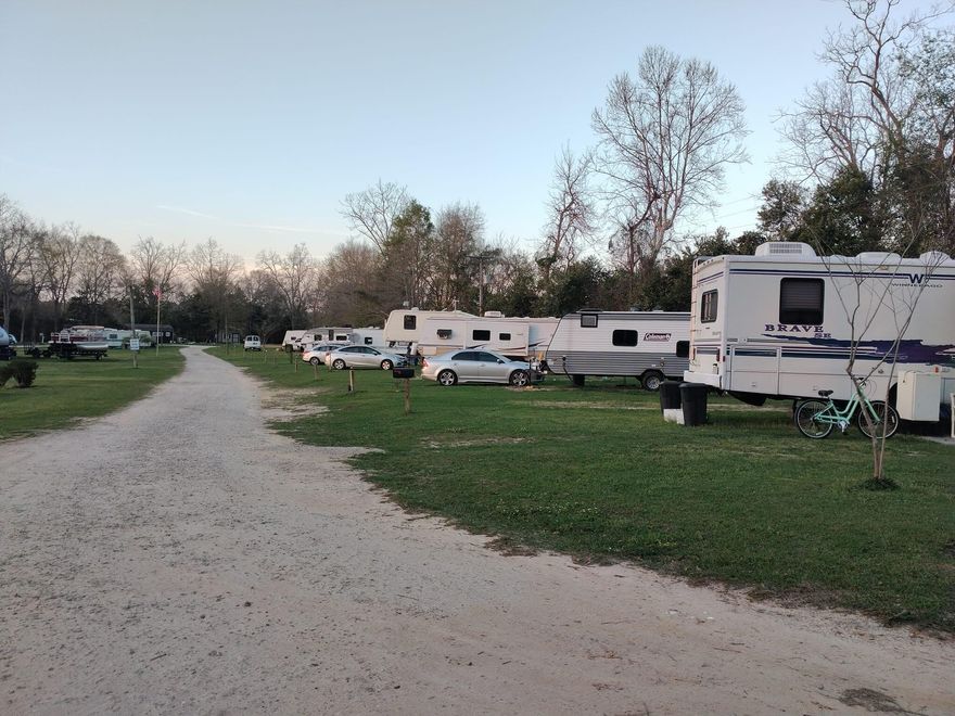 Turnkey, income-producing RV park on nearly 6 treed acres with pecan, sycamore & oak trees. Features 18 RV sites (each with separate electric meters), 2 fully rented tiny homes ($1,000/mo each), and an 1,100 sq. ft. on-site manager's home. 11 long-term tenants on month-to-month leases provide steady, flexible income. Infrastructure includes crushed concrete roads, loop water system, 4 septic tanks & underground utilities. Amenities: spring-fed pond, 3 picnic areas, coin laundry, fiber internet & security cameras. Low-maintenance, high-potential investment with expansion opportunity. Investors--bring all offers!