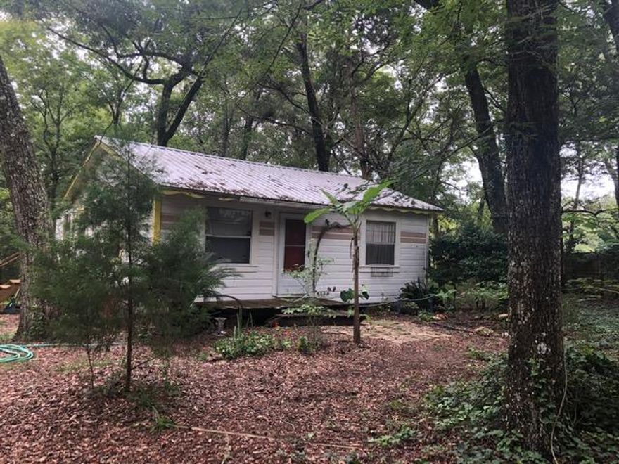 Quaint ''AS IS'' 1965 2 bedroom, 1 bath Fish Camp type property on 2.02 acres (420'x210') in which Mullett Creek runs through the West (or back side) of the property that leads to the bay by kayak, paddle board or canoe. Possibly about 300 ft of creekside along the property with land on the other side. Property most suited for a new home build or manufactured home, a second story can possibly get you great views of the wildlife in the area. Property is situated on the end of a quiet street that adjoins Eglin Air Force Base. Great location for simple, easy living where you can enjoy fishing in your own backyard.