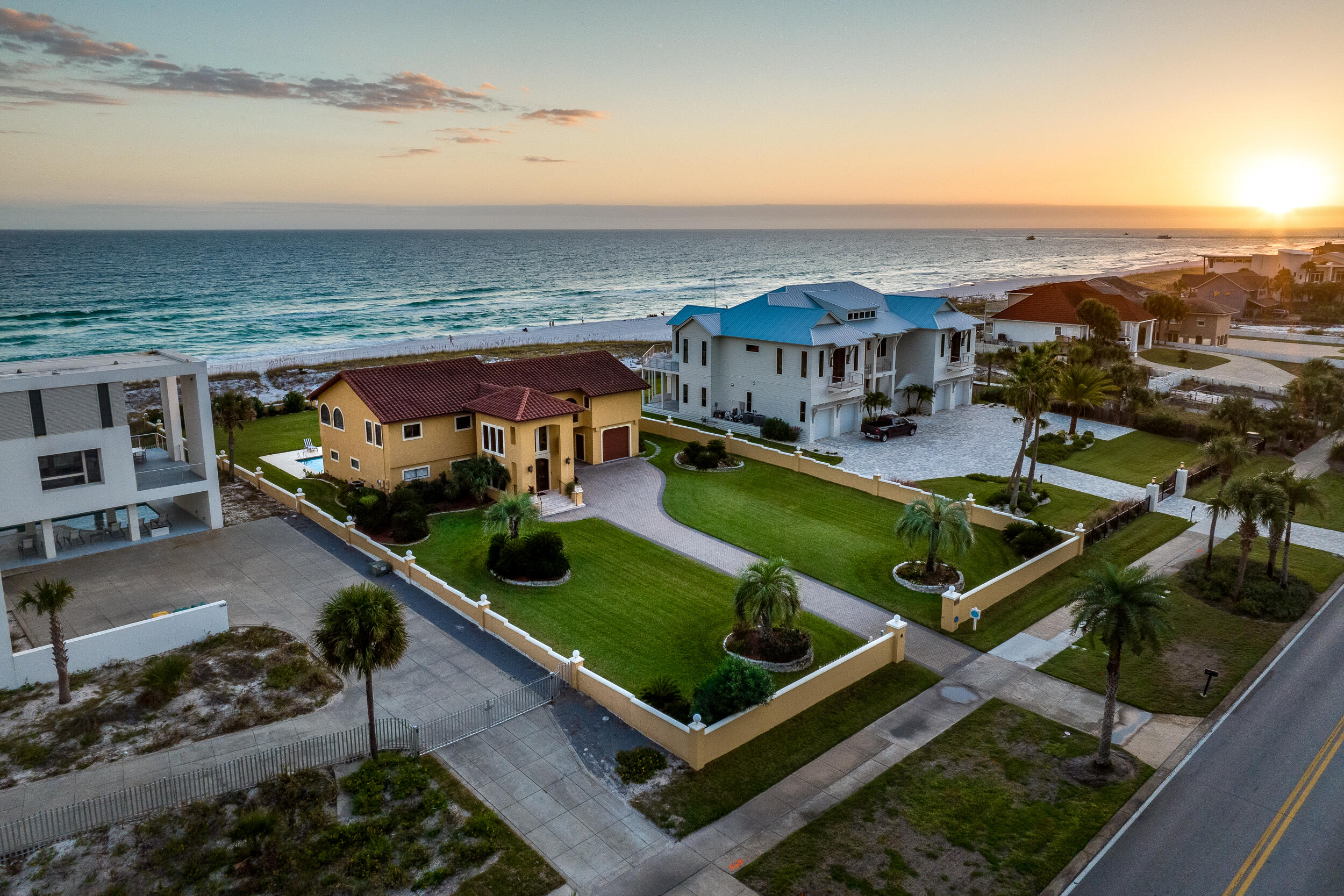 You will be swept up by the Mediterranean styling of this beautiful Gulf front home. Proudly situated on just over one acre, with a 110' expanse of gulf frontage, this property provides plenty of space for family fun! The expansive entry carries you to the next level with sweeping views of the Gulf of Mexico. The second floor offers an open great room, dining area and designer kitchen perfect for entertaining. The enormous master suite features Gulf views, a separate living area, en-suite bathroom with walk in shower, & tray ceiling. Downstairs includes 2 large bedrooms with en-suite baths, plus 2 additional bunk rooms. Outdoors you will find a large in-ground pool with kiddie pool, and expansive lush lawns in front and back.