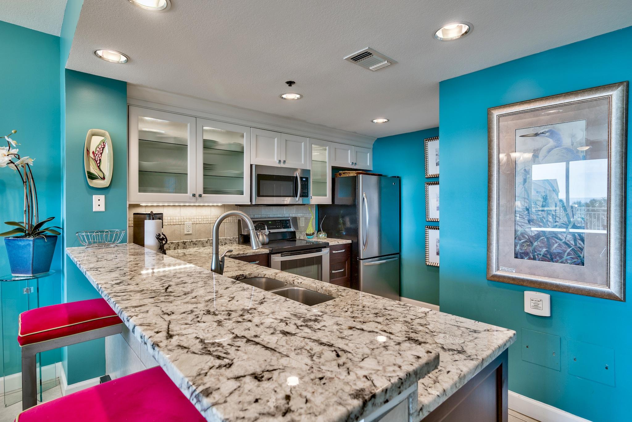 This large 2BR/2BA beachside condo overlooks Sterling Shores 4,300 SF Lagoon pool surrounded by a plush tropical coastal landscape. Rich Designer coastal colors & fabrics set the tone. Kitchen has been totally renovated with custom two tone cabinets, beautiful granite, backsplash & stainless steel appliances. The kitchen is open to the spacious dining & living area designed for entertaining. Wood tile flooring was installed in both BRs. The Master BR & Living Area opens to a 227 SF Balcony. The Master has a large walk-in closet & Master BA that boast an updated Garden Tub & separate shower with a seamless glass door. Both the Master & Guest BA have upscale granite, new faucets, shower heads & lighting. High end drapes have been added...truly a turn-key tropical paradise.