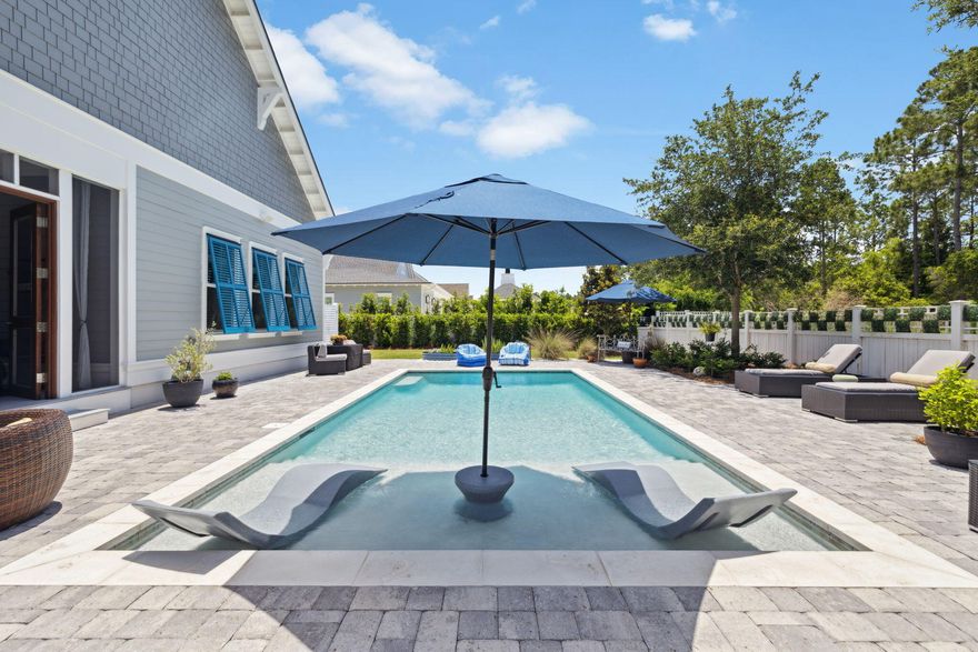 Located on one of the most desirable streets in the coveted Watersound Origins community, 160 Needle Cast Lane is a rare gem built by Cogent on an oversized lot backing up to a tranquil wooded preserve. Surrounded by custom homes, this property combines curb appeal with nearly 4,000 SF of thoughtfully designed living space, PLUS over 300 SF of unfinished area with incredible potential to be converted to a fifth bedroom by adding a window. The interior offers unmatched flexibility with a full 2nd-floor suite for in-laws, teenagers or Au Pair.  Featuring its own living & dining area, a kitchenette with custom cabinets, separate bedroom & full bathroom, additional flex space that's ideal for a Media Room, play/game room, or home fitness with a wall of custom built-ins Downstairs, the open-concept layout centers around a chef's kitchen complete with a large center island (seating for 5), stainless steel appliances including a Fisher & Paykel drawer dishwasher & 5-burner gas range/oven with a custom wood hood & a Sharp drawer microwave. A walk-in pantry provides additional storage to all the cabinets that go up to the 10' ceilings. Featuring under cabinet lights. A built-in wet bar in the dining area makes entertaining seamless. The spacious living room showcases a custom fireplace with wood mantle and exposed ceiling beams, while beachy wood shiplap and thick crown molding add warmth and texture throughout the main living spaces.

In addition the first floor offers three bedrooms, including an expansive Primary Suite with a sitting area, dual vanities, soaking tub, oversized glass shower, and a custom walk-in closet.

Step outside to your private backyard oasis, one of the largest in the neighborhood, highlighting a screened porch with summer kitchen including Blaze 5 burner grill & Blaze 42" outdoor rated hood vent, & Blaze outdoor rated beverage refrigerator. Relax by the heated saltwater pool with sundeck, paver-lined seating area, Napoleon fire-pit, and outdoor shower. The expansive yard has plenty of room for a trampoline, play-set, or pets to roam.

Additional conveniences include a separate mudroom off the garage, a large laundry room with sink, gutters (typically not included in new construction), custom Bahama shutters in the back, 2 custom swings on the front porch, custom built-in's and shelving in all closets. Garage with custom shelving & epoxy floors. Smart Home technology  including Sonos System, & custom lighting throughout the home. For extra privacy protection, there are cameras installed on the front porch, driveway, in the garage & in the backyard.

Sustainability and efficiency are thoughtfully integrated with Tesla-powered solar panels, reducing utility costs and environmental impact.
