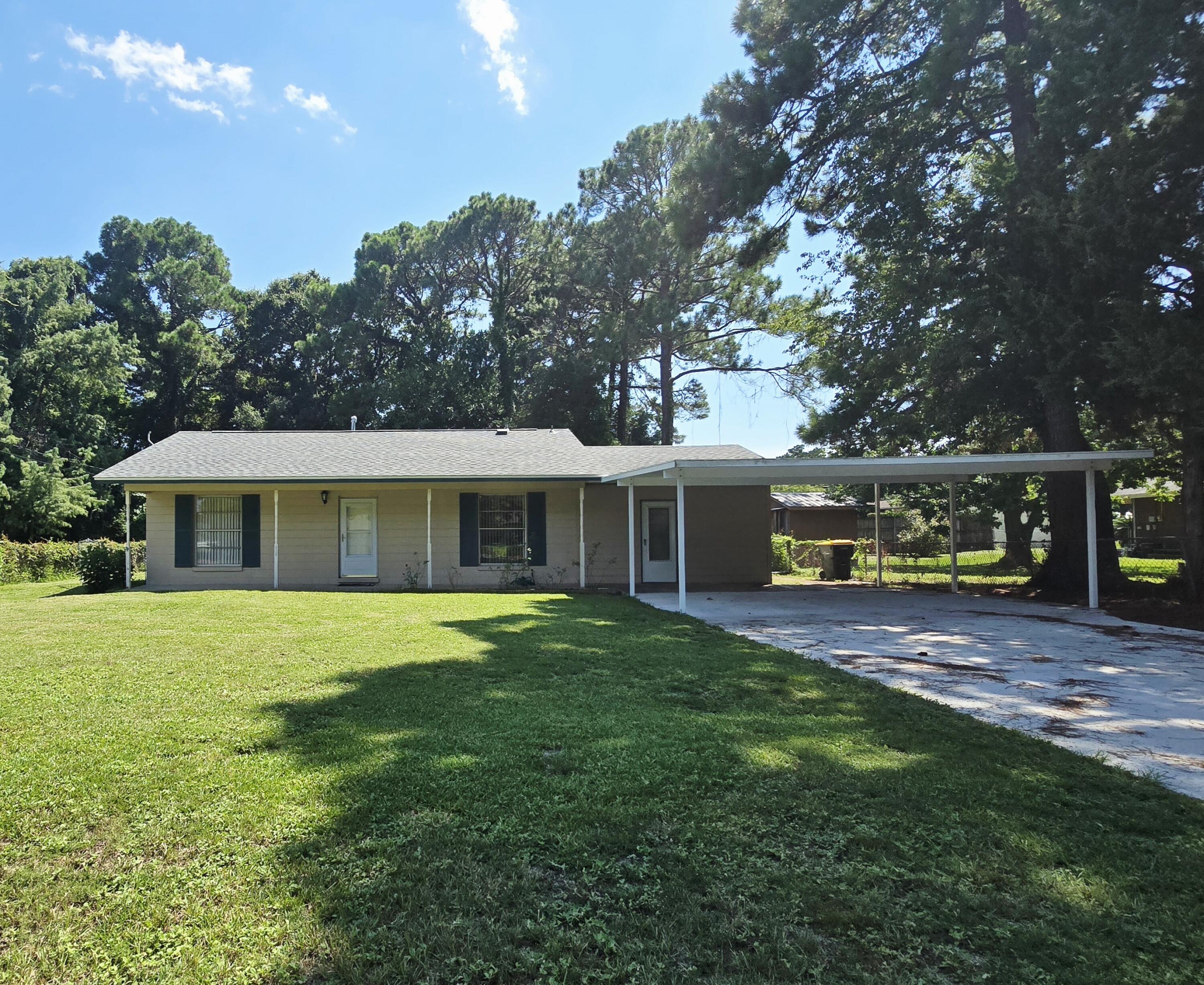 Opportunity Knocking as this home is price to sell! This affordable home is centrally located between Hurlburt & Eglin Air Force Base. New roof & hot water heater replaced in 2023. Eat in kitchen has tiled floors & stainless-steel appliances: dishwasher, smooth top stove, microwave & refrigerator w/ice maker. Kitchen has a deep stainless-steel sink with nickel pull-out faucet. There is plenty of countertop space & cabinet including a side cabinet that can be used as a coffee bar. Newer wood look floors throughout. Spacious living room with ceiling fan. The enclosed garage space would be an excellent den or 4th bedroom addition (new carpet is being installed). Remodeled bathroom tub/shower has tiled backsplash & border. Pedal sink has nickel faucet & a Vanity countertop... Click here The long driveway has been expanded to 20' wide and covered parking was added for two cars with plenty of parking for your guest. This property is close to 1/4 acre with fenced backyard with open patio. There are two storage buildings for extra storage! Professional photos coming soon but don't miss this home. This adorable home is being sold "As Is". Call for your appointment today!!!