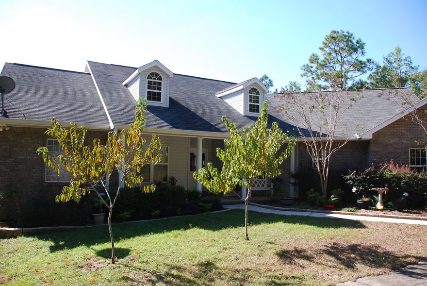 Calling ALL Motorheads and Craftsmen... Don't miss this house!! Oversized two car garage AND room for THREE cars in the downstairs workshop! This brick beauty is nestled on 4.45 acres in town! Plantation style front porch welcomes you into the open floor plan with bamboo and hardwood floors featuring formal dining, corner gas fireplace in great room opening to gorgeous kitchen, breakfast bar and nook. Study with built in bookshelves and beautiful master suite with trey ceiling. Two bedrooms and full bath all located on main floor. Downstairs, you will find an awesome open room (it is heated and cooled) with a bathroom perfect for all of your hobbies and entertaining! Screened porch, wooded acreage and private drive are just a few of the other extras with this house! Call to see it today!!