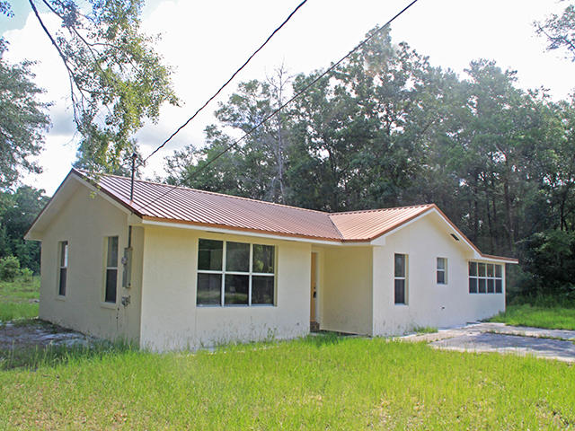 A little tender loving care will turn this 1 story house into a wonderful home. The property consists of 3 large lots totaling 302' x 208' and is located in a quiet nice neighborhood of Paradise in Freeport. This 3 bedroom, 1.5 bath home was built in 1986 and was upgraded in 2008 with a new metal roof, new A/C, new tile floors throughout, new kitchen counters and textured walls throughout. The living room is very large with lots of sunny windows. The kitchen has a breakfast counter along with a breakfast nook. The dining room is separate and could also be used as a family room. This is a great potential investment property as the lots can be separated and a new home can be built on the other 2 lots.