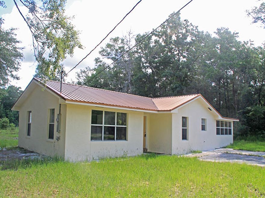 A little tender loving care will turn this 1 story house into a wonderful home. The property consists of 3 large lots totaling 302' x 208' and is located in a quiet nice neighborhood of Paradise in Freeport. This 3 bedroom, 1.5 bath home was built in 1986 and was upgraded in 2008 with a new metal roof, new A/C, new tile floors throughout, new kitchen counters and textured walls throughout. The living room is very large with lots of sunny windows. The kitchen has a breakfast counter along with a breakfast nook. The dining room is separate and could also be used as a family room. This is a great potential investment property as the lots can be separated and a new home can be built on the other 2 lots.