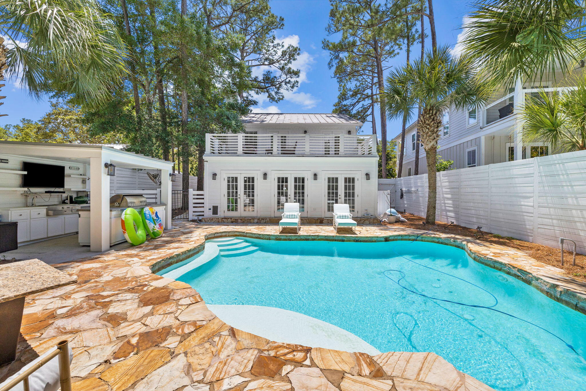 LOCATION! LOCATION! LOCATION!  124 Canal Street in the heart of Santa Rosa Beach, FL centrally located along the famous Scenic 30A. This stunning cottage-style home is the perfect blend of modern amenities and natural charm. The 2,823 square foot home boasts 5 bedrooms and 4 bathrooms, including a bunk room.Upon entering the main house through a gated courtyard, you'll be greeted by a modern galley kitchen that opens to the dining and living areas. The dining room features a cozy fireplace and abundant natural light. The home is full of character and unique details, including built-ins and storage solutions throughout.