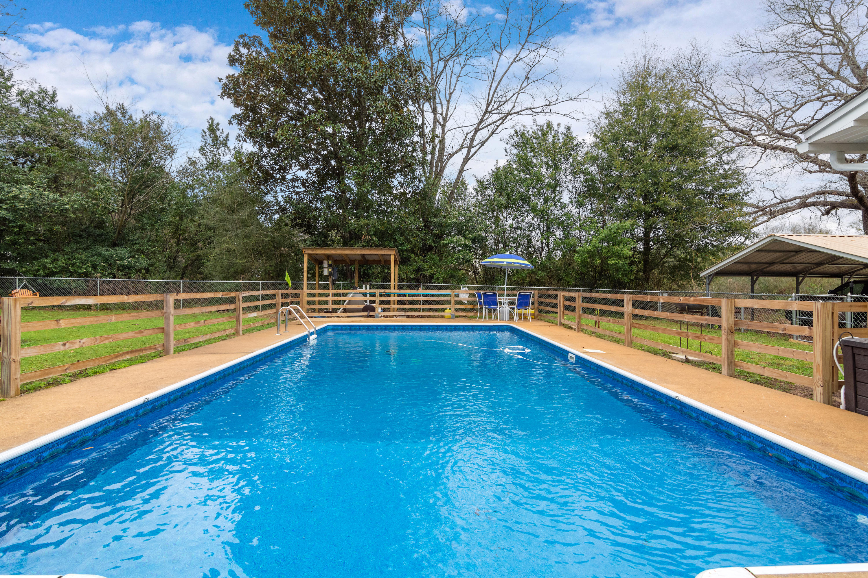 Due to having received multiple offers, the seller requests that all buyers send in their highest and best offer no later than 10 am on 2/22/19. IN-GROUND SWIMMING POOL!! Situated on a 1/2 acre lot, this adorable 3 bd/2 ba cottage style home w/ inviting front porch is located just minutes to town. Fresh paint and laminate flooring throughout in 2017. Sleek black cabinetry w/ coordinating countertops, stainless steel appliances and adjoining dining area. Large master suite w/ dual closets (one houses the washer/dryer which will convey). New roof in 2017!! Entertaining will be a delight from your screened-in back porch overlooking a large fenced backyard and beautiful in-ground swimming pool (new liner and pump in 2017). See supplement