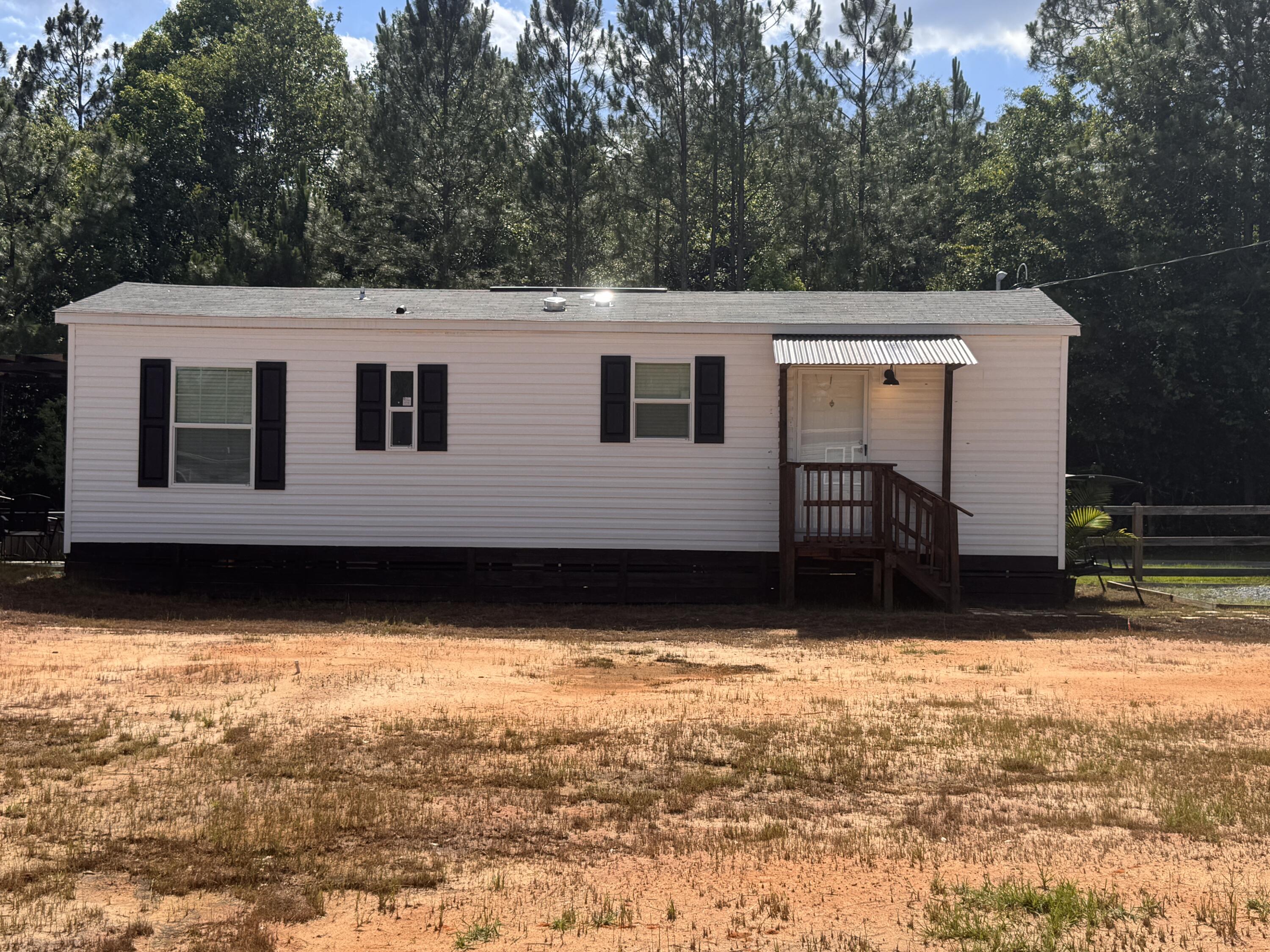 4-unit Potential - Incredible Investment Opportunity: Instant Income & Room to Grow! Get ready to seize a rare opportunity that combines immediate rental income with expansive future potential. This standout property centers on a brand-new 15x40 mobile home featuring 1 bedroom and 1 bathroom, currently leased and generating solid cash flow through February 2026. The lot is primed for expansion with two additional sites already set up for mobile homes - complete with pre-installed water lines and a fully connected septic system servicing all three sites. The electric company's power pole at the street ensures that adding extra units is a breeze. Adding to its appeal is an adjacent 600-square-foot unfinished building, framed and ready to be transformed into a stylish tiny home. Whether you envision boosting rental income further or crafting a unique personal project, the possibilities are endless. This is an exceptional opportunity for investors seeking both immediate returns and long-term growth. Don't miss the chance to call this dynamic property your own!