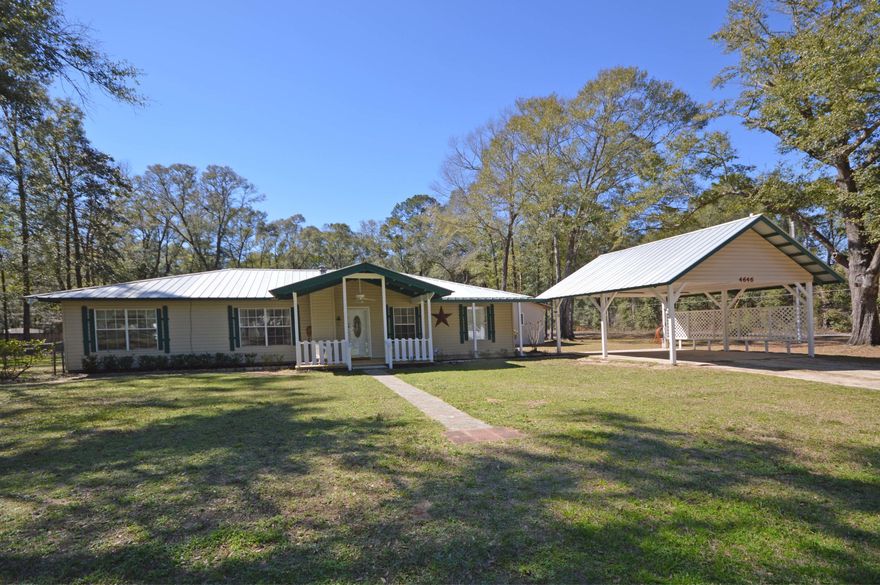 Come home to the country, Holt is the best kept secret in north west Florida, quant and cozy this adorable doll house of a home sits on an entire city block, no one in front or behind you, while its a little over an acre it feels like 2 acres.  walking distance to grocery's, gas and the post office.  Baker School is a 12 year school separated on campus this allows siblings to attend school together as in the old days..... This home has so much to offer, there is 3 bedrooms in the main house with a glassed in breeze way that carries over to a very large suite including a private bathroom and the room to set up as the kitchen.  Excellent place for the in-laws or young adult wanting to feel there independence. Home has so much to offer, detached garage and work shop, rv hook and parking pads