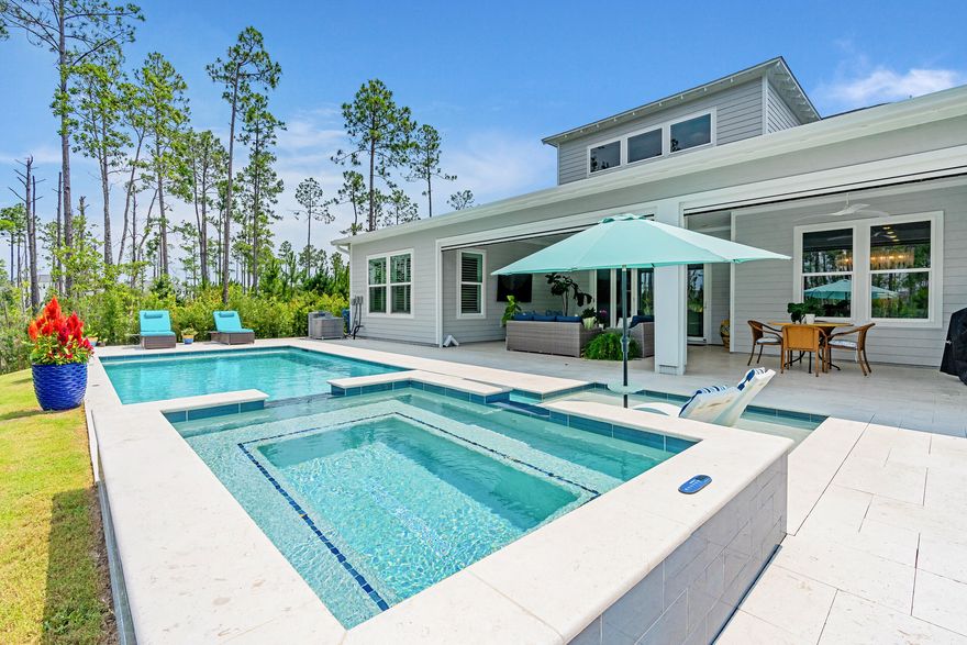 Welcome to the Venice floor plan--an exceptional 5-bedroom, 4.5-bath home offering luxury, flexibility, and privacy, all ready for immediate move-in. Thoughtfully designed for multi-generational living, this home features two bedrooms on the main floor, including a spacious primary suite. The two-story living room is an architectural showstopper with a striking linear fireplace framed by floor-to-ceiling tile, creating a dramatic focal point that flows seamlessly into the outdoors. Step through the 5-panel sliding glass doors to your massive covered porch, equipped with motorized screens and overlooking a beautifully paved patio. It all opens up to one of the largest and most private pool and spa retreats in the neighborhood, backed by serene woods on two sides for unmatched privacy. Inside, the gourmet kitchen is a chef's dream, outfitted with high-end GE Caf?? appliances, including a 60" gas cooktop and an oversized refrigerator and freezer. Just off the kitchen, you'll find a generous laundry room and a beverage hub featuring multiple wine fridges and an ice machine- perfect for entertaining, whether you prefer red or white. The main-floor primary suite boasts a spa-like bath with a soaking tub, oversized shower with multiple heads, and a customized walk-in closet with built-ins. An additional en suite bedroom and a bright, inviting office complete the first floor.

Upstairs, discover three more bedrooms (one en suite) and an open loft-style living space perfect for relaxing or hosting guests. Lovingly maintained and loaded with designer upgrades- including custom lighting, built-ins, and plantation shutters- this home is like new, but better. Located in NatureWalk at Watersound Origins, enjoy easy access to top-rated schools, Publix, local dining, and the beautiful beaches of 30A. Don't miss your chance to own this one-of-a-kind home in one of the most sought-after neighborhoods on the Emerald Coast. Schedule your private showing today!