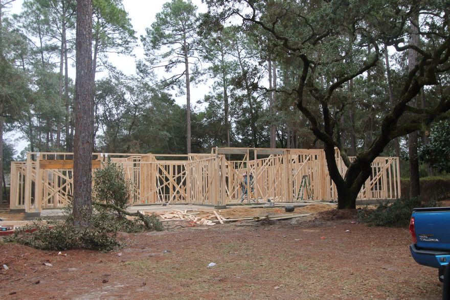PICTURES ARE OF A SIMILIAR HOME!!! BRAND NEW CONSTRUCTION STARTED ON 12/31/14. NEARLY AN ACRE OF LAND WITH BEAUTIFUL MATURE TREES! GARAGE IS OVERSIZED WITH PLENTY OF ROOM FOR A WORKSHOP AREA. CONTRACT NOW TO CUSTOMIZE!! FLOORING, CABINETRY, LIGHTING, COUNTERTOPS, ETC. MAY BE CHOSEN AT THIS TIME. THE MOMENT YOU ENTER THIS EXQUISITE HOME, YOU WILL FALL IN LOVE ITS UNIQUE DESIGN. THE MAIN LIVING AREAS WILL HAVE 11 FT. CEILINGS, 5 1/4'' BASEBOARDS, IMPRESSIVE CROWN MOULDING AND BRAZILIAN HAND SCRAPED HARDWOOD FLOORING, JUST TO NAME A FEW OF THE EXTRAS INCLUDED IN THIS HOME. THE GOURMET KITCHEN WILL HAVE STAINLESS APPLIANCES (INCLUDING A COMMERCIAL GRADE BUILT IN FRIG./FREEZER), RAISED PANEL MAPLE CABINETRY, GORGEOUS GRANITE COUNTERTOPS, A BREAKFAST BAR, AND A HUGE PANTRY. DO YOU ENJOY ENTERTAINING? HOME HAS A FORMAL DINING ROOM, AN OVERSIZED GREATROOM WITH GORGEOUS CROWN MOULDING AND A  LARGE COVERED PORCH. THE MASTER SUITE IS AWESOME!!! IT IS OVERSIZED, 2 LARGE W/I CLOSETS, A BATH W/ SEPARATE SHOWER, WHIRLPOOL TUB, DOUBLE VANITY AND LINEN CLOSET. THERE IS A HOME OFFICE/STUDY THAT IS LOCATED AT THE RIGHT OF THE MASTER. HOME IS BUILT TO THE STANDARDS OF GULF POWER'S NEW ''EARTH CENTS'' ENERGY EFFICIENCY PROGRAM. HOME HAS A TAEXX ''IN THE WALL'' PEST CONTROL SYSTEM THAT IS SERVICED FROM THE EXTERIOR OF THE HOME, FOR THE OWNERS CONVENIENCE. YARD COMES COMPLETE W/ TROPICAL LANDSCAPING, A SPRINKLER SYSTEM, WELL, PUMP AND TIMER. PLEASE KEEP THIS HOME AT THE TOP OF YOUR LIST!  COMPLETION DATE IS EXPECTED IN APRIL.