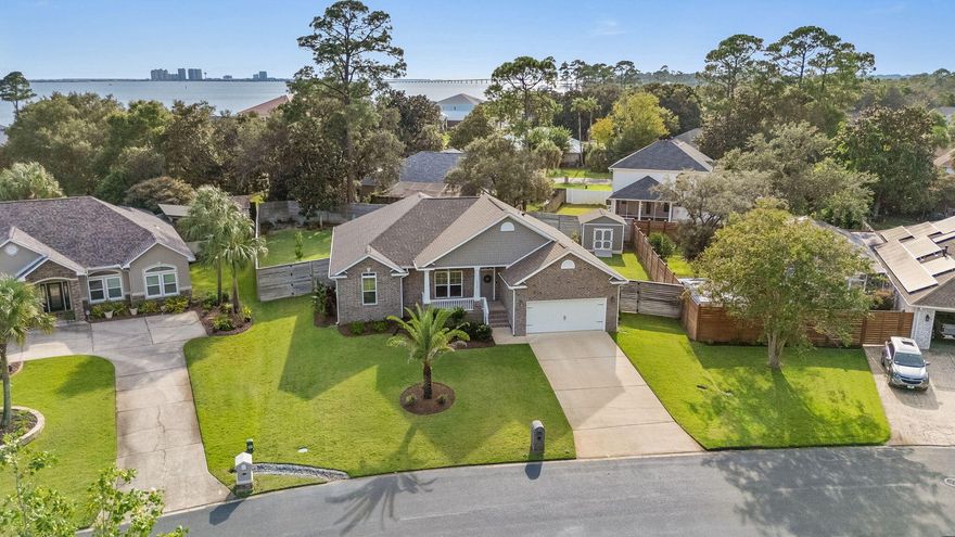 Meticulous 4-Bedroom Brick Home with Deeded Water Access in Biscayne Pointe! Welcome to this absolutely pristine, like-new 4 bedroom, 2 bath home in the highly desirable Biscayne Pointe community--where you'll enjoy not only a beautifully maintained home but also exclusive deeded water access to the Santa Rosa Sound. Launch a kayak or paddleboard, or simply relax by the water--just steps from your own home! Inside, you're greeted with soaring ceilings and an abundance of natural light that fills every corner. The open layout flows seamlessly, highlighted by two stunning picture windows in the dining room, a bright neutral color palette, and wood-look tile flooring throughout the main living spaces. The chef's kitchen is designed for both beauty and function with custom wood cabinetry, granite countertops, stainless steel appliances, a center island, and a walk-in pantry with custom shelvingproviding exceptional storage and organization. The split floor plan ensures privacy, with the spacious master suite overlooking the backyard and featuring a spa-like ensuite with a glass-enclosed shower, soaking tub, and a large custom-organized walk-in closet. Step outside to your own backyard retreat complete with an expansive covered porch, fully fenced yard, cozy fire pit, lush professional landscaping, irrigation with private well, and a charming storage shed perfect for hobbies or extra space. Opportunities like this don't come oftena meticulously maintained, newer construction home with deeded water access in one of Navarre's most desirable communities. Ideally located close to top-rated schools, white sand beaches, shopping, dining and Hurlburt Field. Experience elegance, efficiency, and Florida lifestyle living at its finest. Schedule your showing today before it's gone!