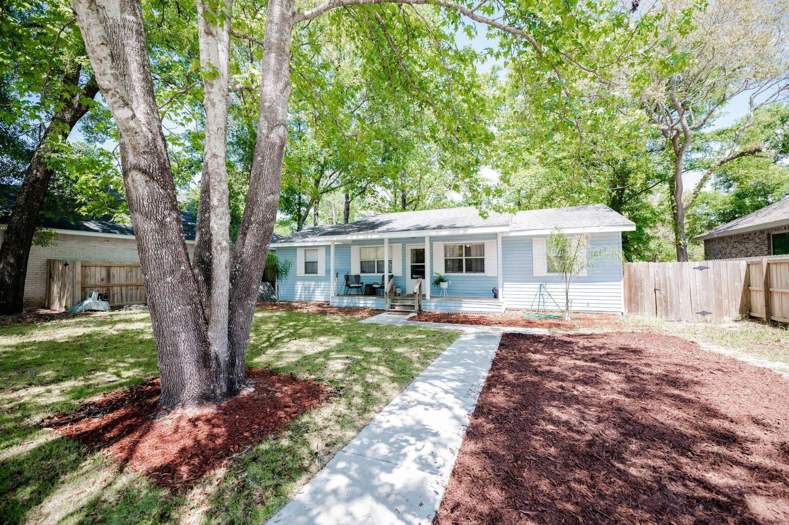 No HOA. Prime location in Niceville!  Spacious kitchen is open to the living area with a breakfast bar.  Kitchen features newly painted solid oak cabinets. Utility room has a pantry area and shelving for storage.  Washer and dryer are included in the sale.  Master bedroom with tray ceiling and 2 walk-in closets.  The expansive bathroom was completely remodeled in 2020.  Beautiful oak trees add shade to this charming, fully fenced in backyard.  The driveway and sidewalk were added in 2022.  Stained deck is 15x27 with a firepit for relaxing on cool evenings.  Privacy fence around the back yard was installed in 2021. Storage shed on slab. HVAC 2019. Roof 2005. Water heater 2011