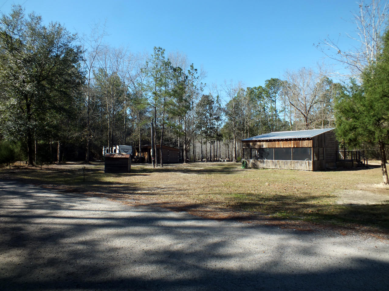 Great little cabin for someone looking to getaway from the weekend crowds of the beach communities or for a snowbird heading south for the winter. It comes fully furnished and only the stereo system does not convey. The interior rooms are perfect for a couple and are in excellent condition. The front screened porch provides a great outdoor relaxation area. The pole barn shed will hold a small boat and can be secured when you are away. The pond is spring fed and is even prettier to look at when the lily pads are in bloom. The 4+ acres provide privacy and a place to relax, while being close to the beaches, dining and shopping of south Walton and Bay counties.