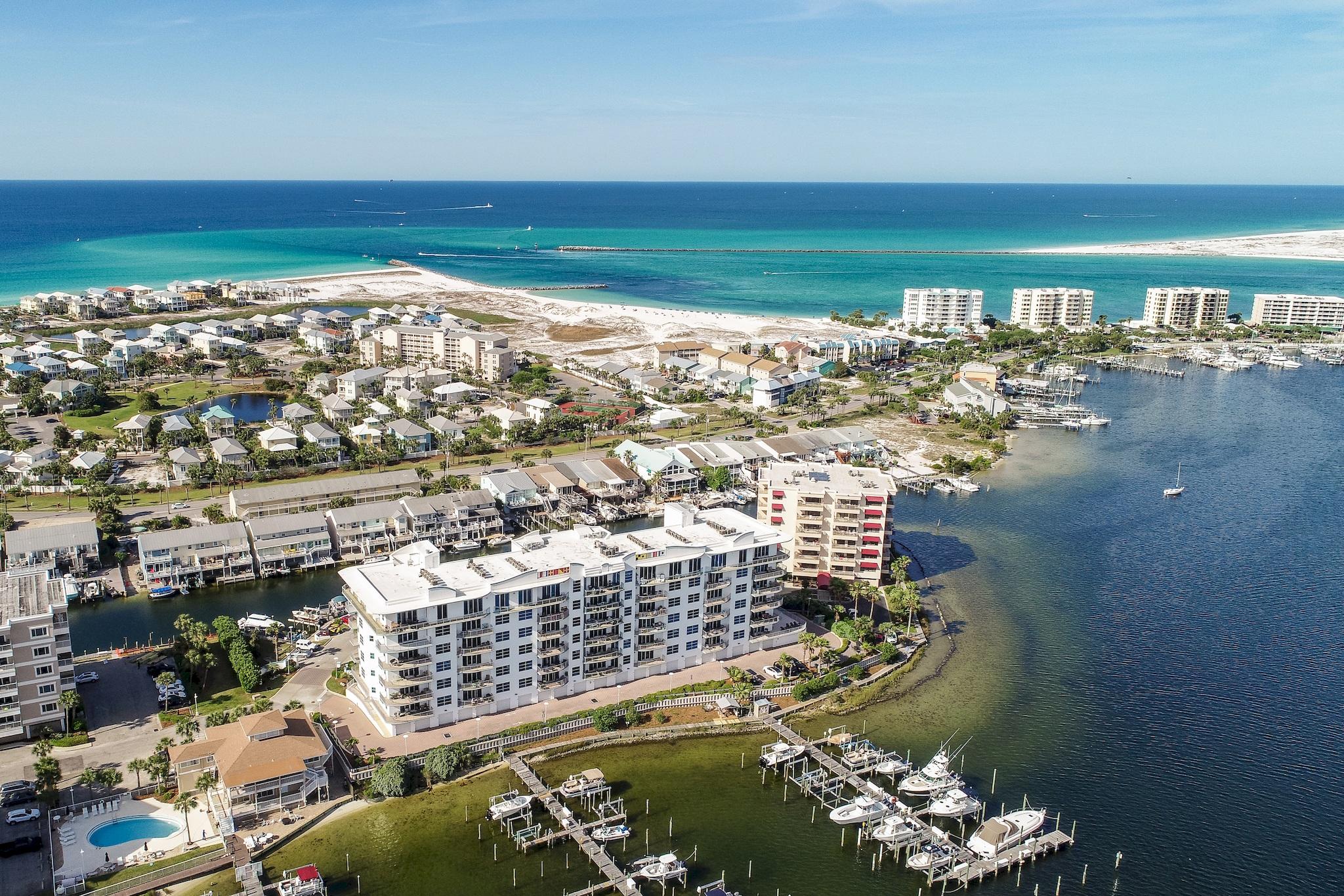 Looking for mesmerizing, panoramic water views in a luxurious, quiet complex with NO boisterous weekly renters? Want to BUY RIGHT & purchase a beautiful corner unit priced $195,000 LESS than similar units for sale in the same complex and only $49,000 more than a 2 BR unit!Imagine warm, salty breezes & a glass of wine from your 480 SF of balconies with front row viewing of the harbor, its activities and Thursday night firework shows during summer months. Enjoy stunning sunsets & then grab a water taxi to a nearby oceanfront restaurant. Only an elevator away from boating, paddle boarding, fishing, swimming, gym, steam & sauna & more, start living the lifestyle you've always dreamed of! Offering stunning harbor, east pass and Gulf views from almost every room, from the