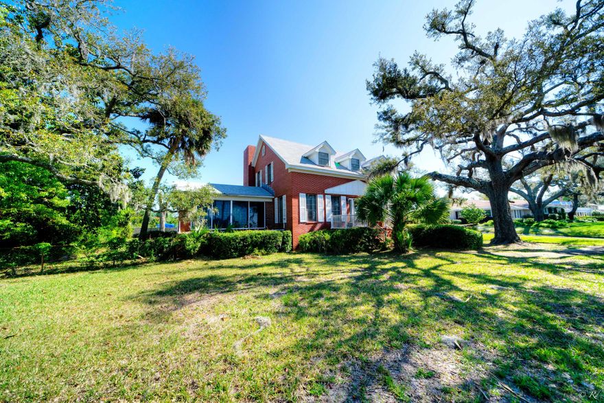 Location!! Bask in the gorgeous Florida sunsets settling over the Bay from the privacy of your own home and private beach! Wind down and watch the ships sailing through while enjoying views of Shell Island. This 3 bed, 3 bath colonial style home is situated on a double lot on one of the most coveted streets in town, nestled among mature trees. This property leads all the way to the water, providing a peaceful and serene spot to create lasting memories with family and friends. This home will wow you with its space and character! The main floor of the home boasts a Florida room, den, kitchen and formal dining area with a fireplace. The main floor also features an office with faux fireplace and beautiful, bead board ceilings and walls. The Florida room has shiplap ceilings and sliding glass