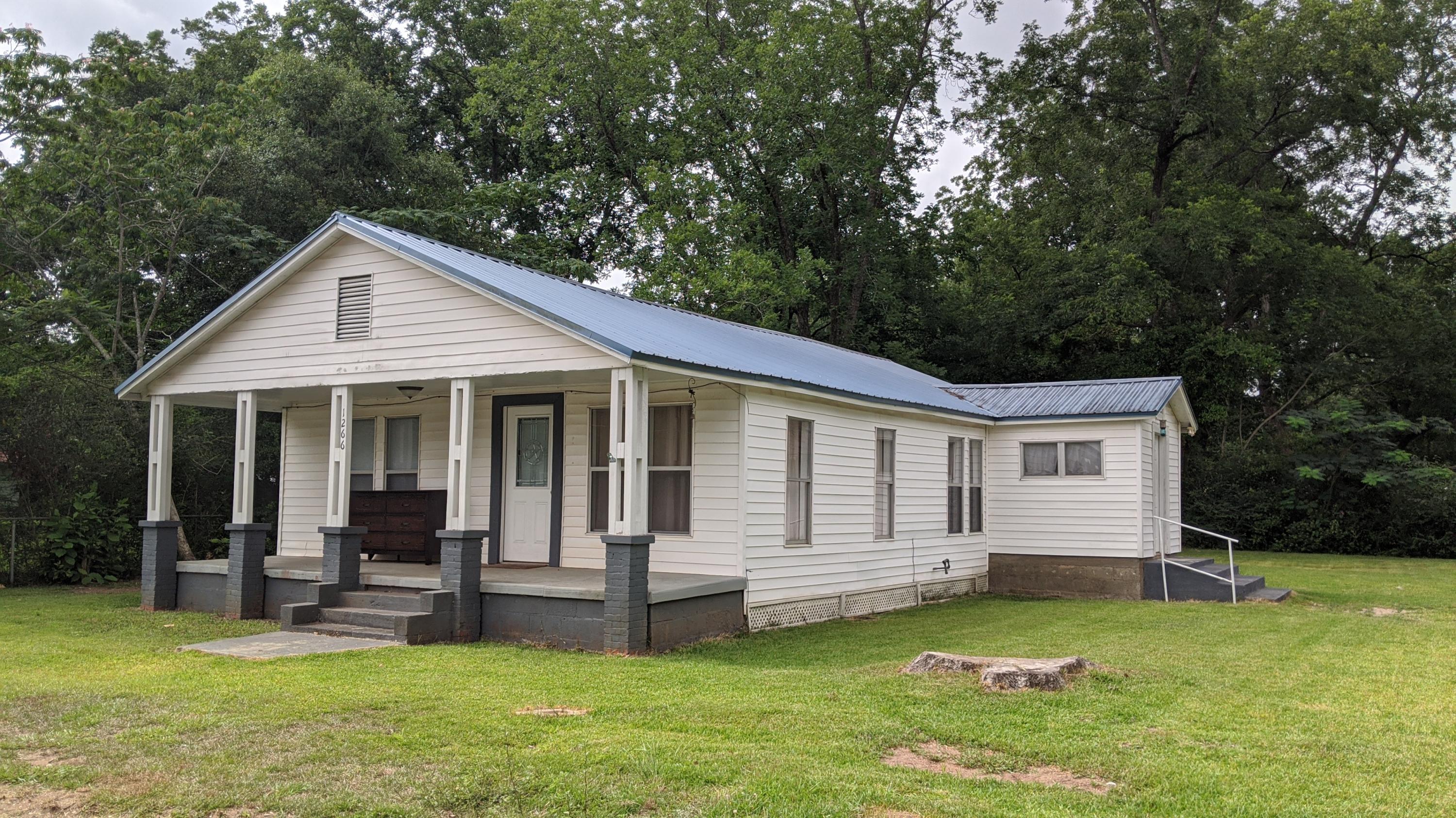 Wow! Two properties for the price of one! Quaint Home with lots of Historic Charm in the heart of Baker Florida!! Lots of upgrades and will pass a 4-pt inspection! Natural wood flooring through out main part of home and tile in baths and kitchen. Kitchen with a recent remodel, newer appliances, cabinets and beautiful tiled backsplash. Bathroom has a nice stand up tiled shower. Additional parcel to convey has potential commercial value and has a large out building that could be used for storage or potential business. It's up to you what to do with it! Come out and look at the potential of this property today!